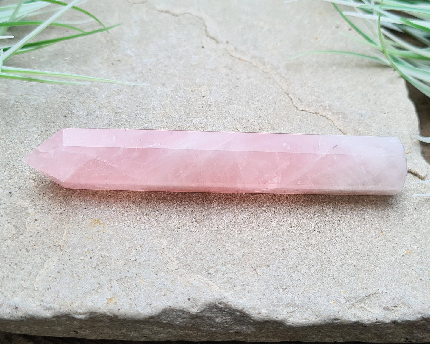 Rose Quartz Crystal Polished wand from Brazil. One end is a 6 sided point and the other end is rounded.