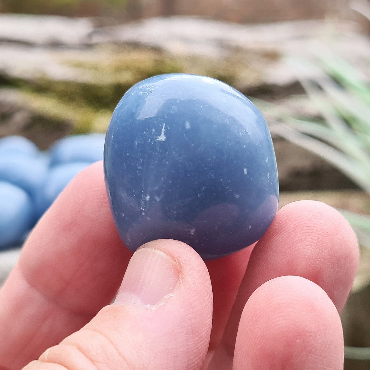 Angelite Extra Large Tumble Stones from Peru feature a soft greyblue tone with natural white flecks of Calcite or Gypsum. Formed from Celestite over millions of years, these soothing stones carry a calming yet grounded presence. Their energy supports communication, compassion, and spiritual connection.