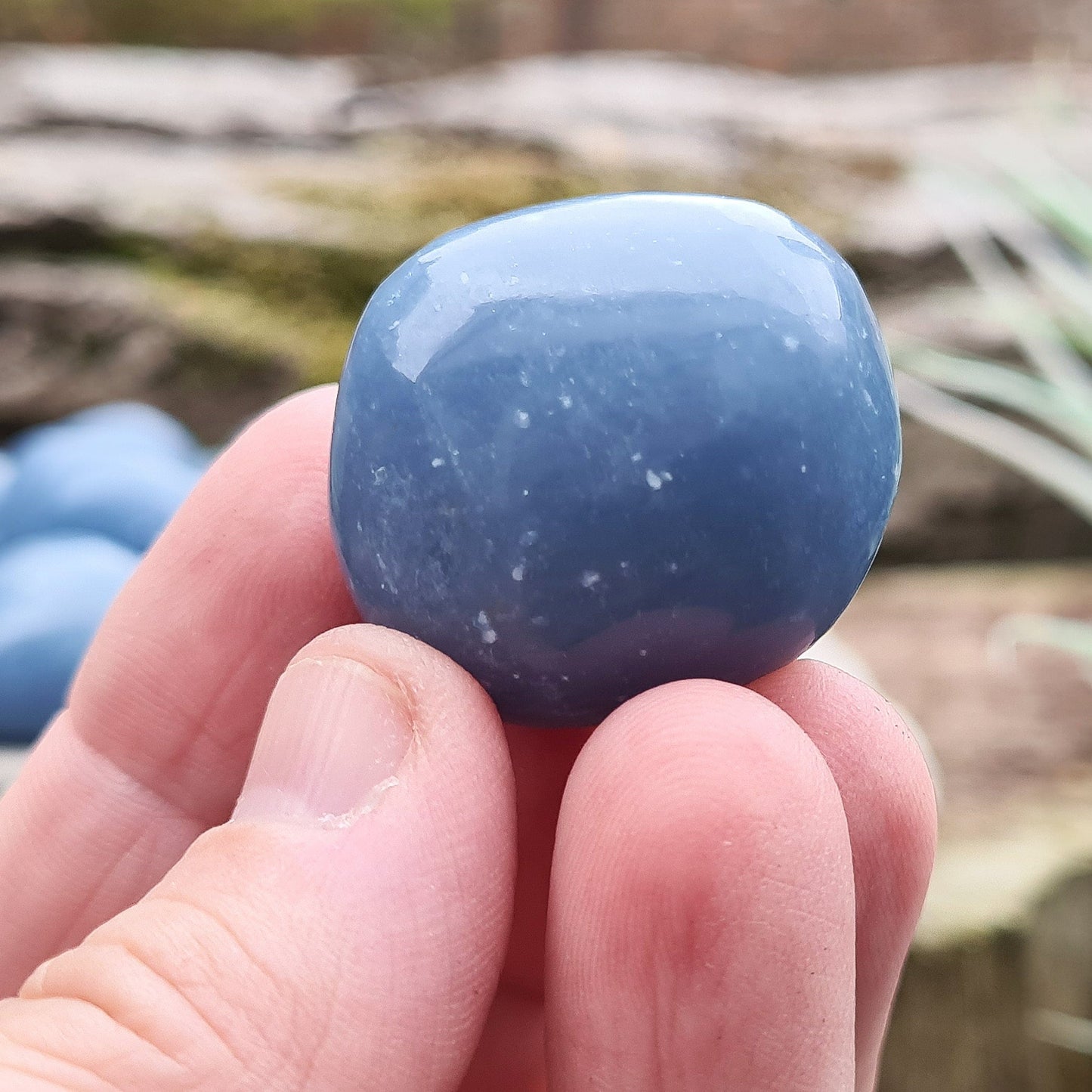 Angelite Extra Large Tumble Stones from Peru feature a soft greyblue tone with natural white flecks of Calcite or Gypsum. Formed from Celestite over millions of years, these soothing stones carry a calming yet grounded presence. Their energy supports communication, compassion, and spiritual connection.