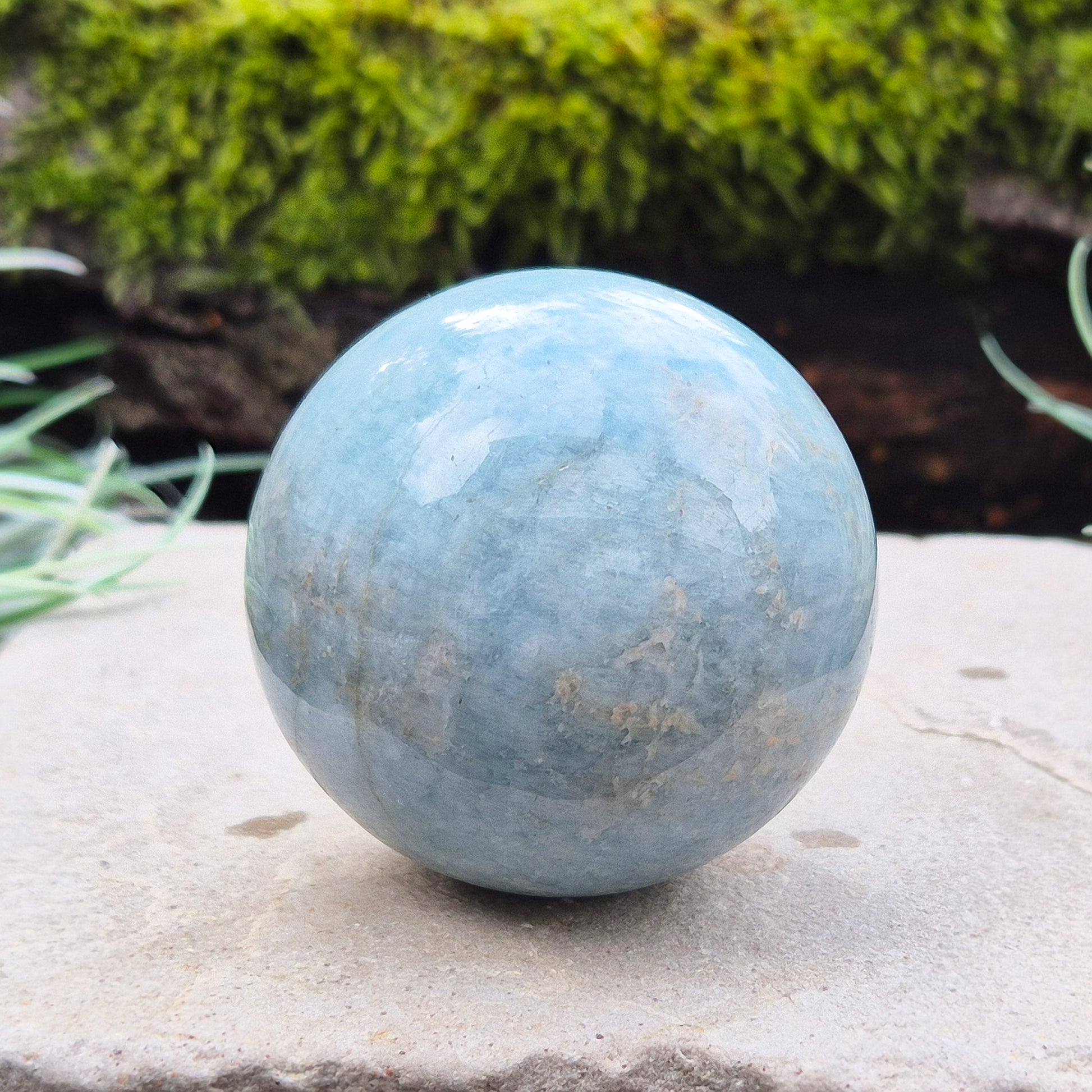 Enhance your space with an Aquamarine crystal sphere. Known for tranquility and clarity, it’s perfect for meditation and decor.