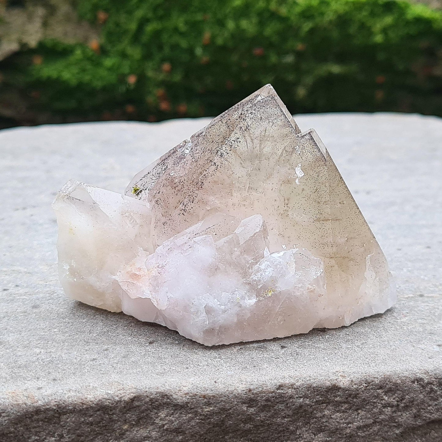 This beautiful Ametrine with Hematite Crystal Standing Point comes from China. A colour shines through in natural light, with a double polished tip, natural body, and a cut base. The addition of Hematite grounds Ametrine’s mental clarity and spiritual uplift, creating a deeply balancing and energising piece.