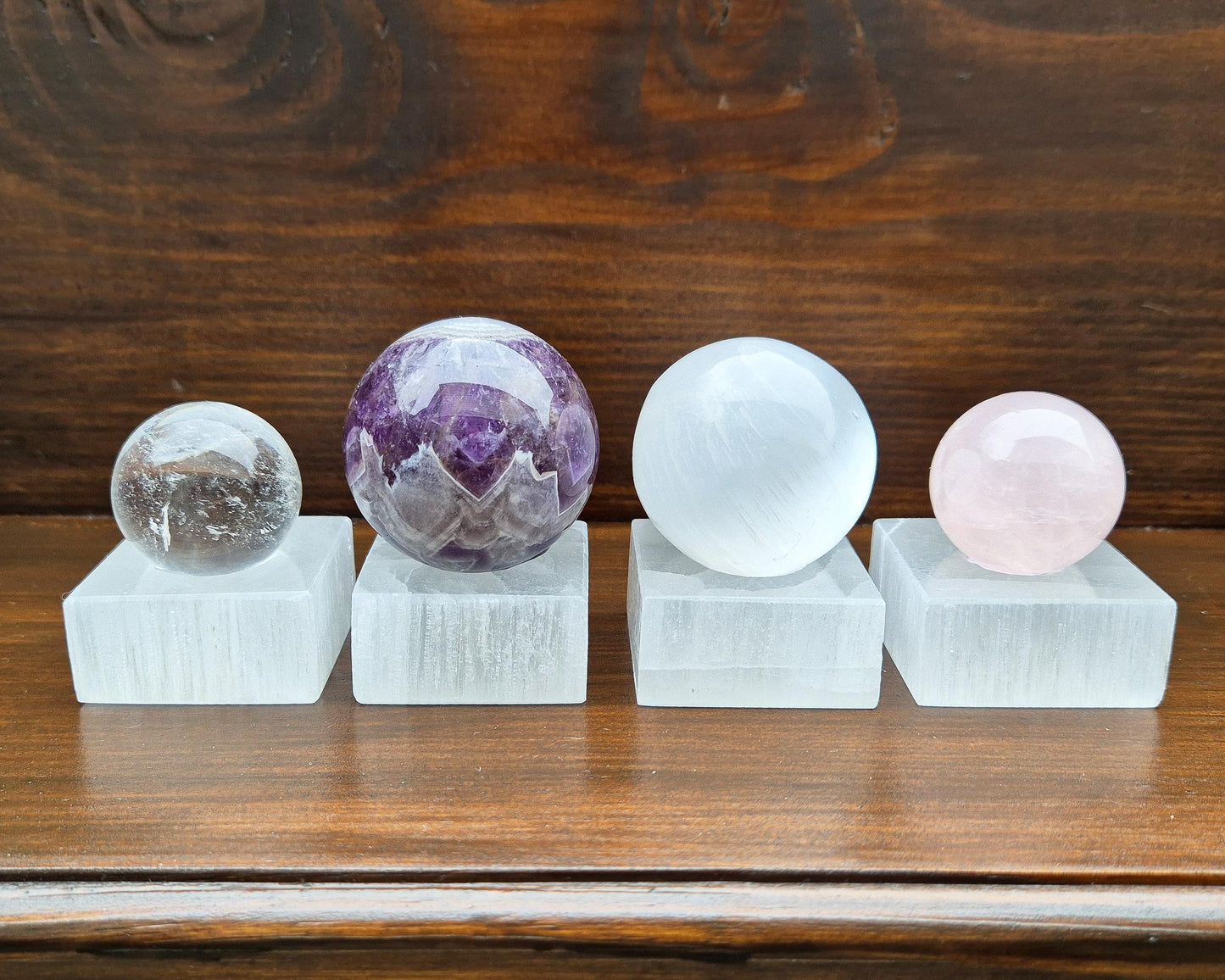 This elegant Mini Selenite Crystal Ball Stand is designed to support and display your crystal spheres while keeping their energy clear and refreshed. Made from natural Selenite sourced from Morocco