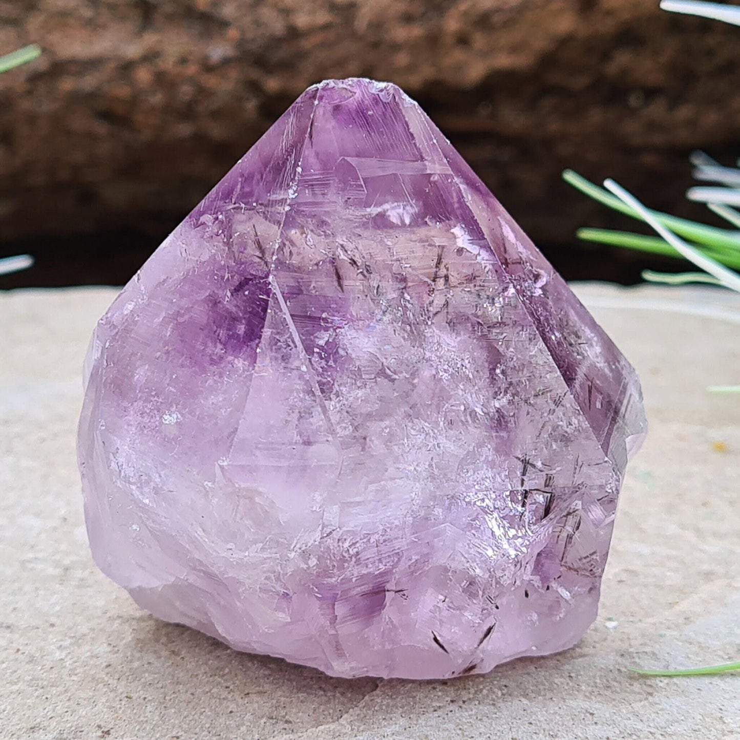 Amethyst Crystal Point with Goethite Inclusions. Beautiful purple color with black Goethite inclusions. Polished point with a natural body and cut base.