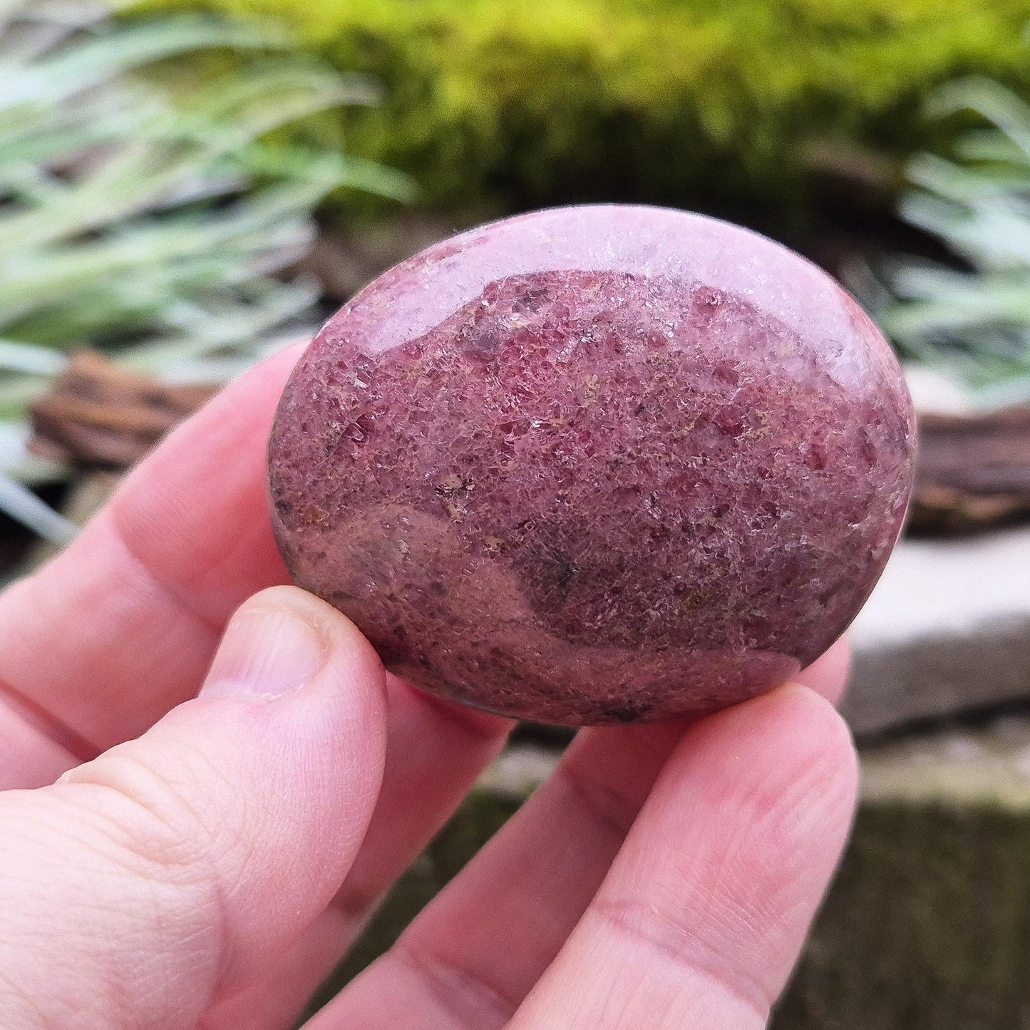 Rhodonite Crystal Pebble - Polished. Lovely shimmer on the surface. Crystal lovers often connect with Rhodonite for its steady, reassuring energy.