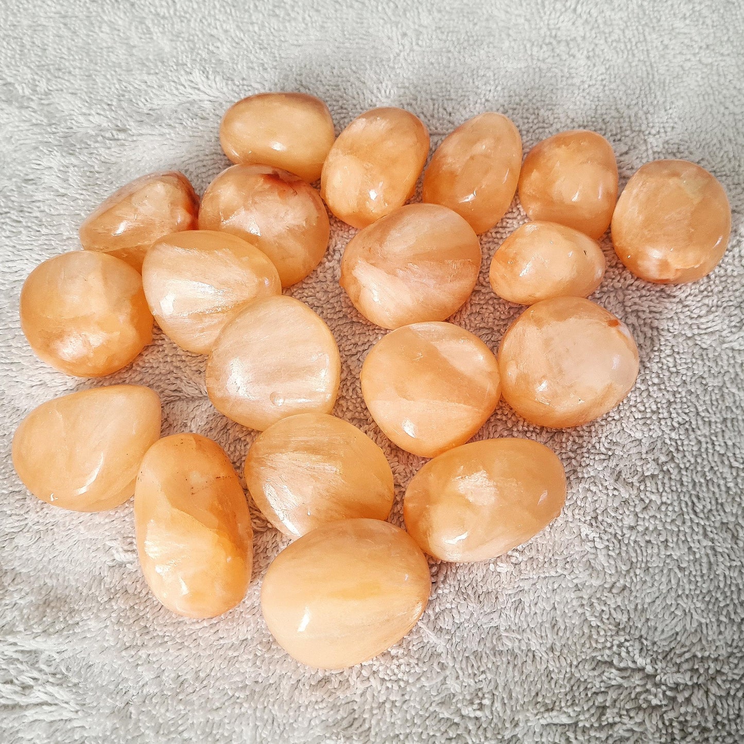 Stilbite Tumble Stone, AA Grade from India features a beautiful opalescent peach color. This crystal is prized for its gentle, loving energy that supports intuition, creativity, and spiritual growth.