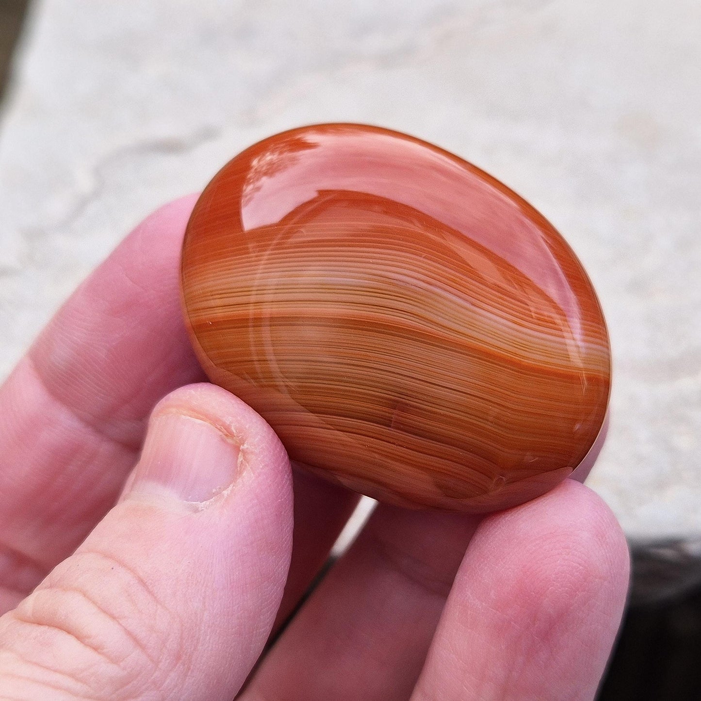 Carnelian Crystal Palm Stone. From Madagascar. This palm stone has a wonderful orange and white banded colouring.