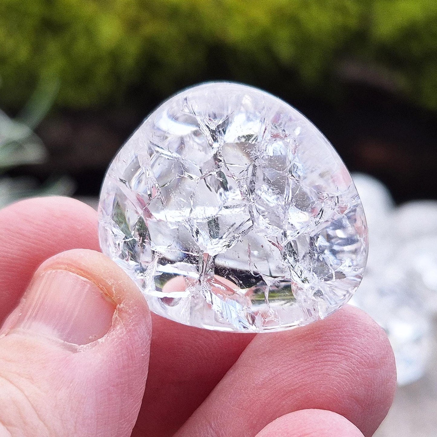 Crackle Quartz tumble stone. Crackle Quartz is a dazzling crystal with remarkable clarity and a radiant sparkle, created through a unique heating and cooling process that forms stunning internal fractures.