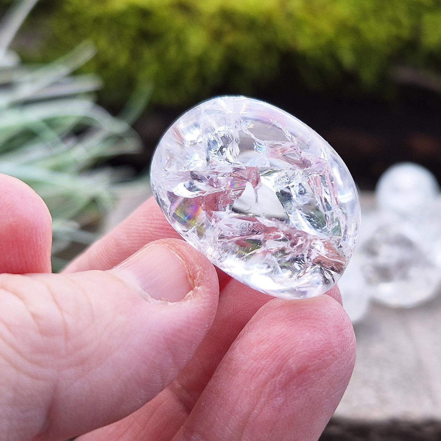 Crackle Quartz tumble stone. Crackle Quartz is a dazzling crystal with remarkable clarity and a radiant sparkle, created through a unique heating and cooling process that forms stunning internal fractures.