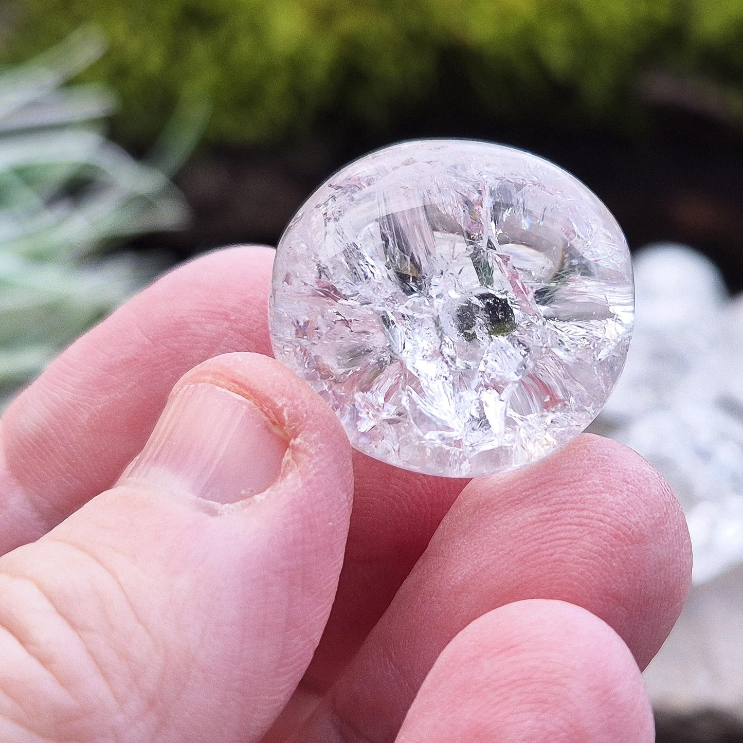 Crackle Quartz tumble stone. Crackle Quartz is a dazzling crystal with remarkable clarity and a radiant sparkle, created through a unique heating and cooling process that forms stunning internal fractures.