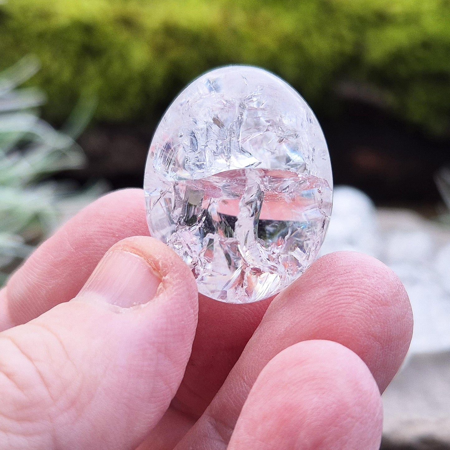 Crackle Quartz tumble stone. Crackle Quartz is a dazzling crystal with remarkable clarity and a radiant sparkle, created through a unique heating and cooling process that forms stunning internal fractures.