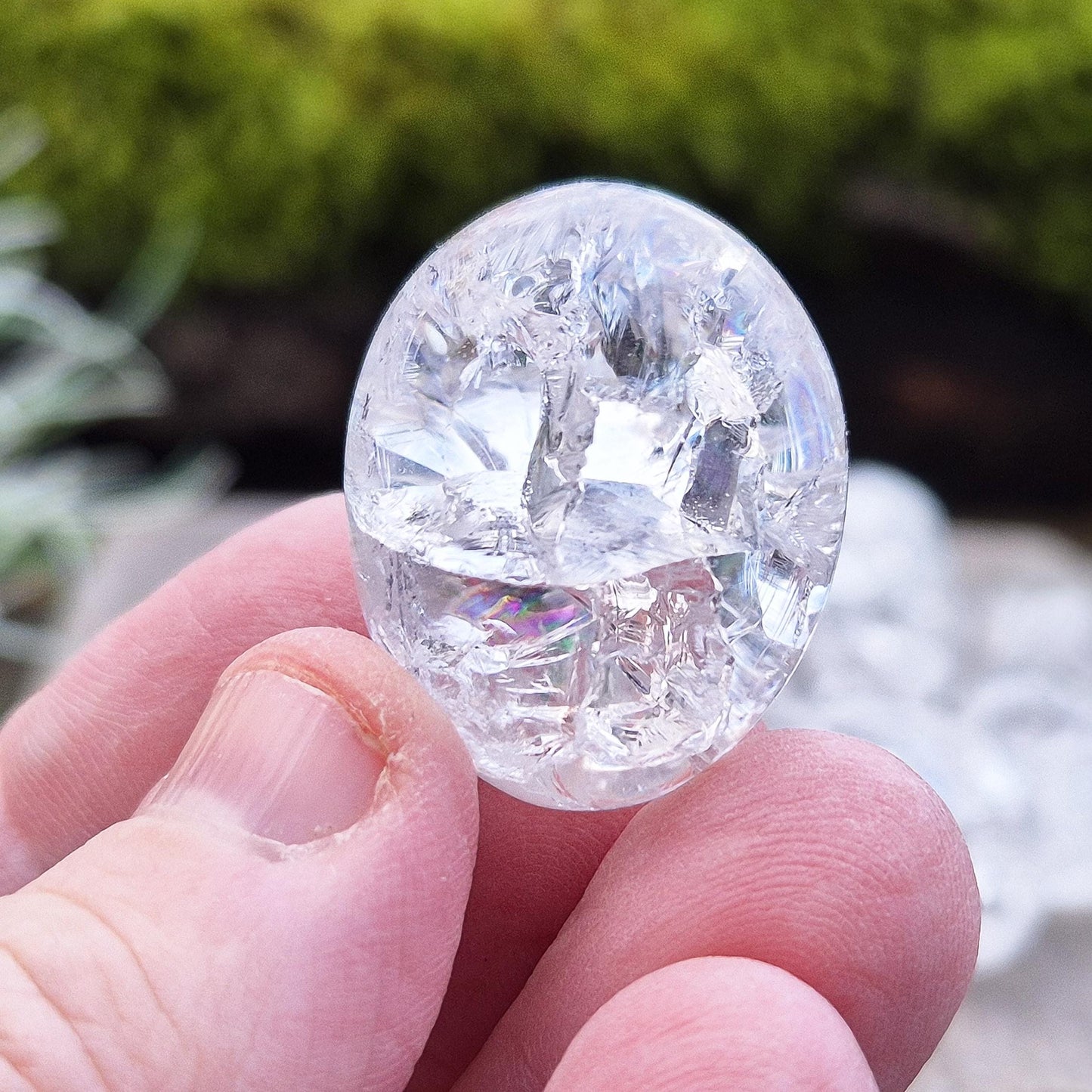 Crackle Quartz tumble stone. Crackle Quartz is a dazzling crystal with remarkable clarity and a radiant sparkle, created through a unique heating and cooling process that forms stunning internal fractures.
