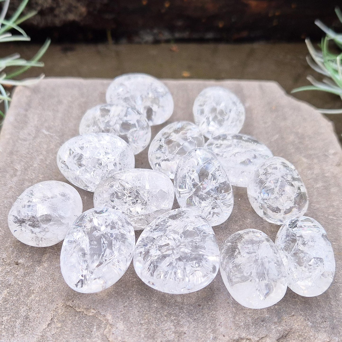 Crackle Quartz tumble stone. Crackle Quartz is a dazzling crystal with remarkable clarity and a radiant sparkle, created through a unique heating and cooling process that forms stunning internal fractures.