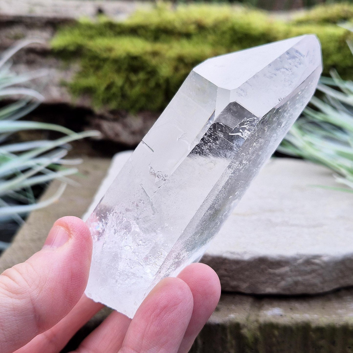 Quartz Crystal Point. From Brazil. This is a wonderfully natural quartz point with wispy inclusions and nice clear clarity towards the top of this point. This crystal point offers an authentic, natural touch to any collection.