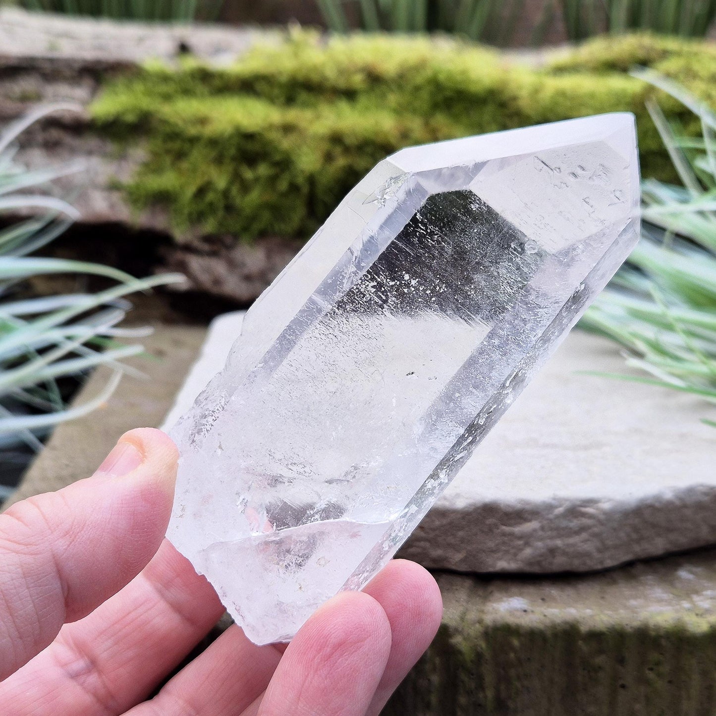 Quartz Crystal Point. From Brazil. This is a wonderfully natural quartz point with wispy inclusions and nice clear clarity towards the top of this point. This crystal point offers an authentic, natural touch to any collection.