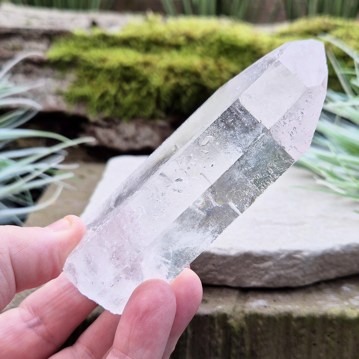Quartz Crystal Point. From Brazil. This is a wonderfully natural quartz point with wispy inclusions and nice clear clarity towards the top of this point. This crystal point offers an authentic, natural touch to any collection.