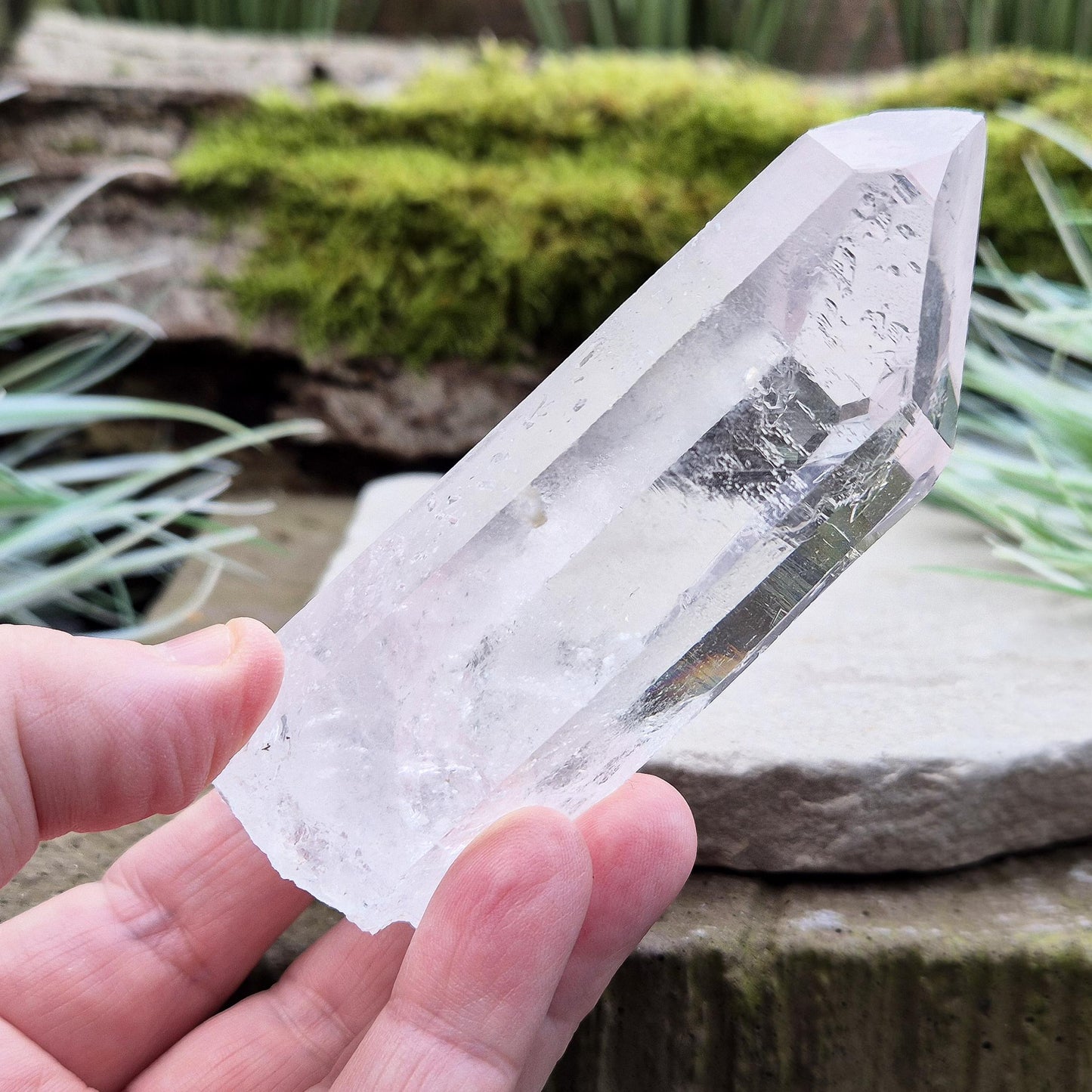 Quartz Crystal Point. From Brazil. This is a wonderfully natural quartz point with wispy inclusions and nice clear clarity towards the top of this point. This crystal point offers an authentic, natural touch to any collection.