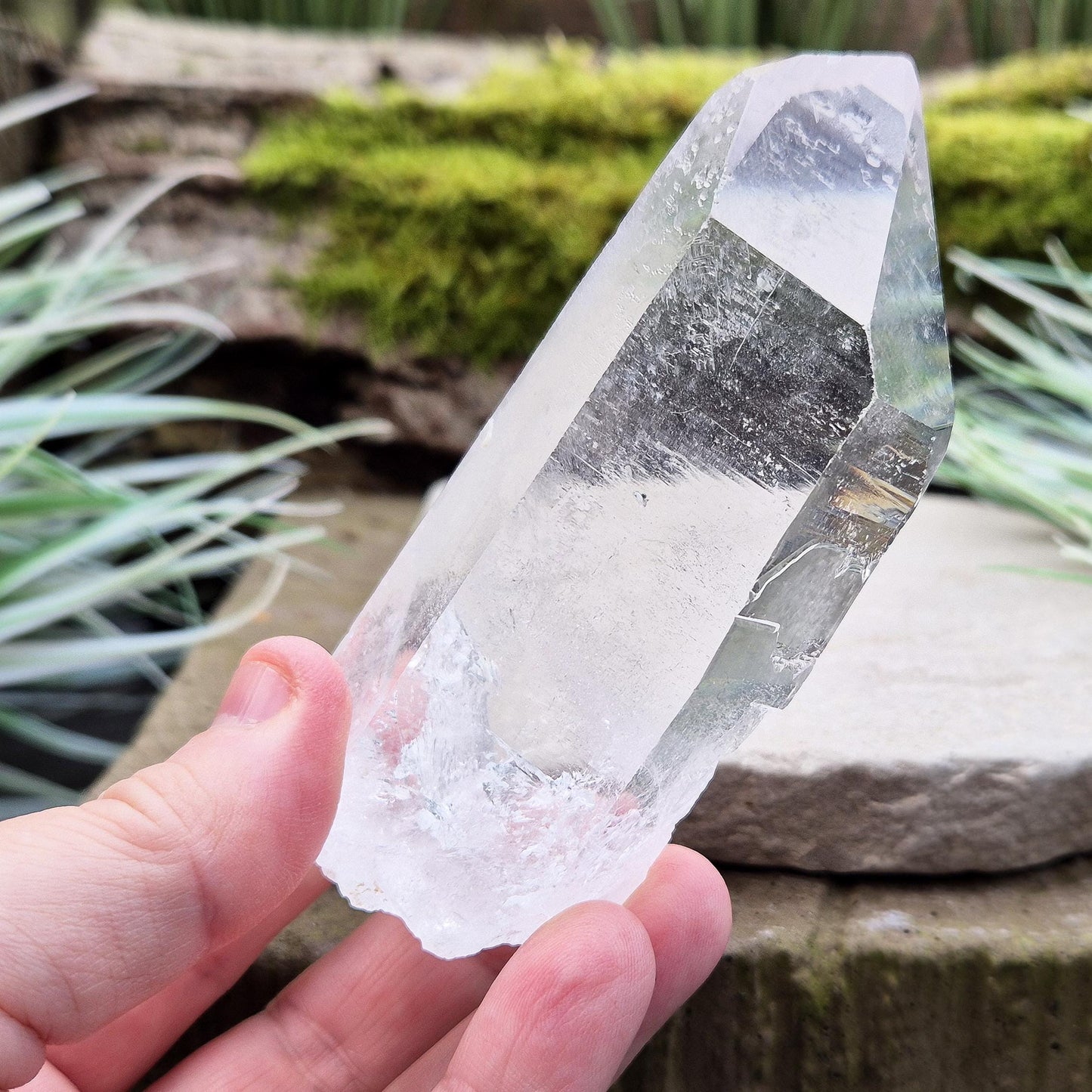 Quartz Crystal Point. From Brazil. This is a wonderfully natural quartz point with wispy inclusions and nice clear clarity towards the top of this point. This crystal point offers an authentic, natural touch to any collection.