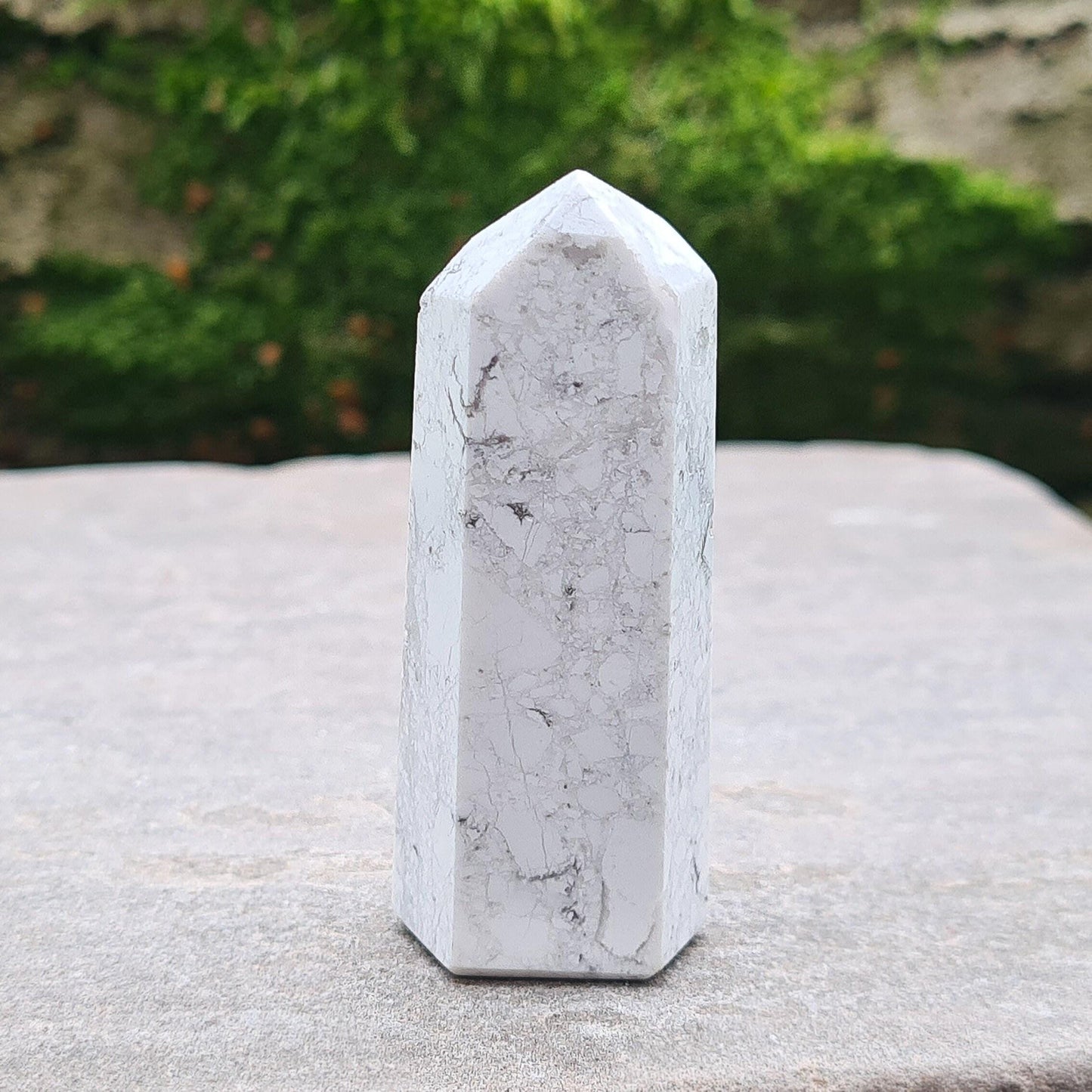 Howlite Crystal Point. Off white with grey marble like patterning, nicely polished.