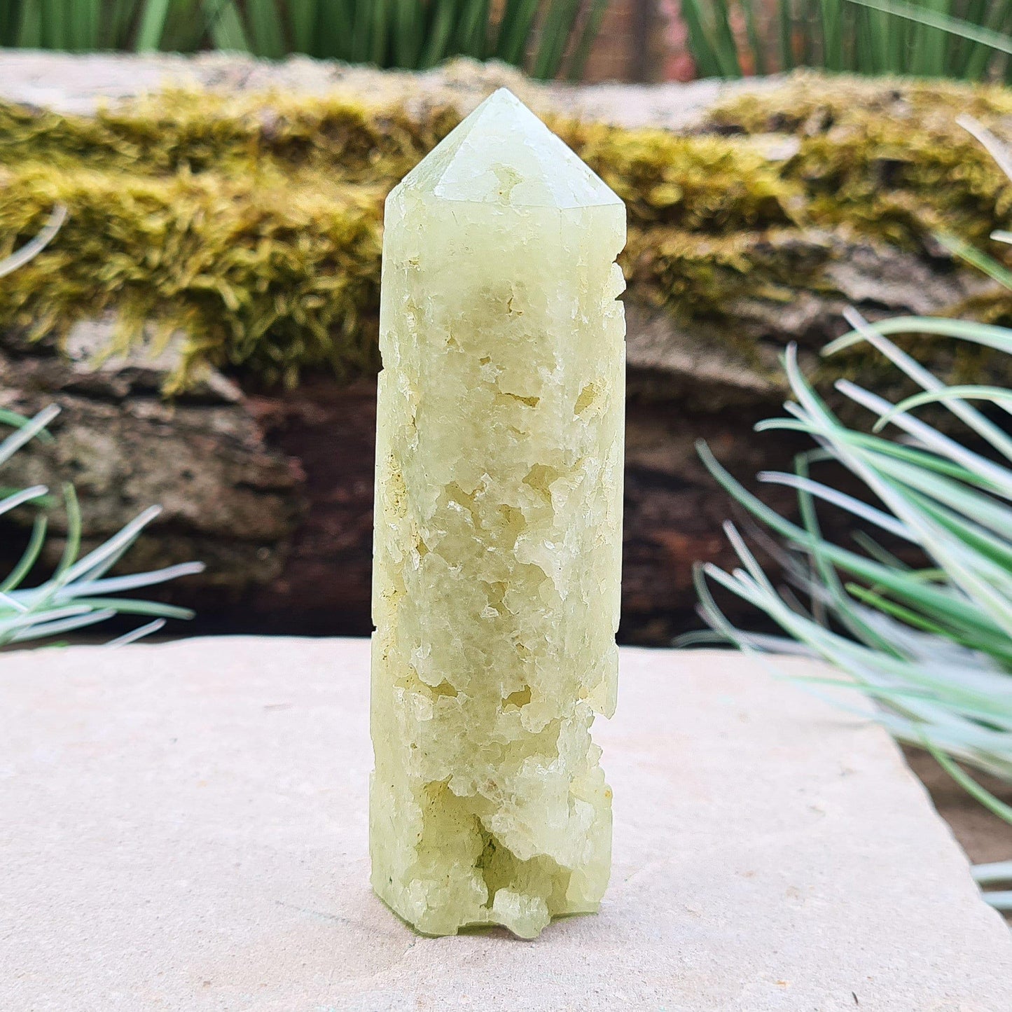 Prehnite Crystal Tower, point is a 6 sided Generator, has lovely natural cavities so you can see the crystalline structure within it. The prehnite is a lovely pale green. From Victoria, Australia.