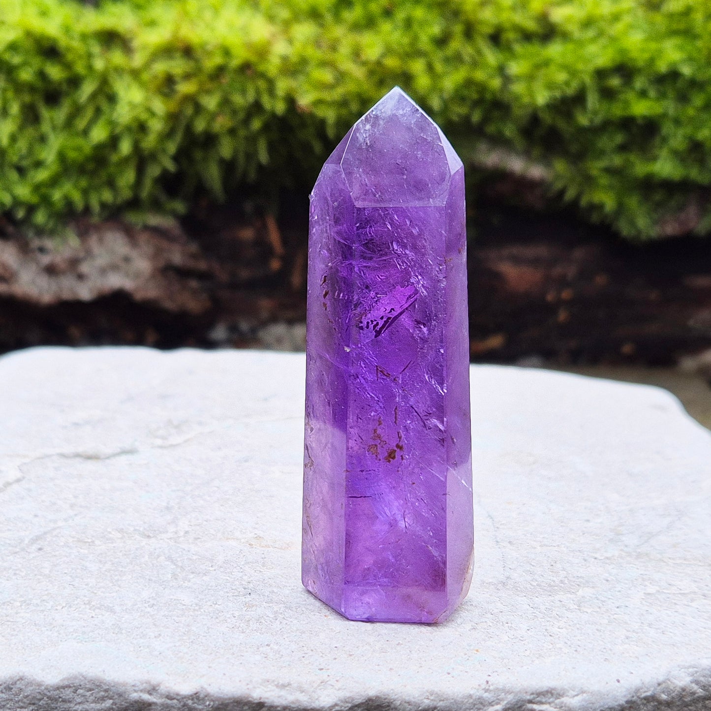 Amethyst Crystal Point from Brazil. Nice dark purple colouring with a patch of quartz at the base of the tower giving it a unique look.
