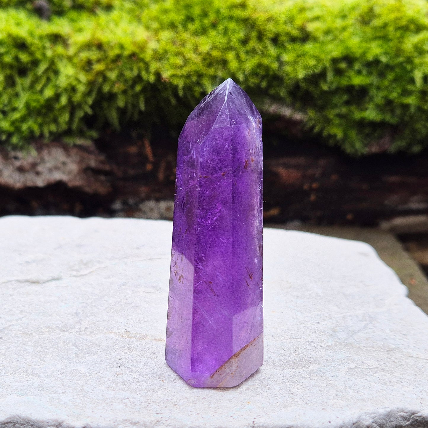 Amethyst Crystal Point from Brazil. Nice dark purple colouring with a patch of quartz at the base of the tower giving it a unique look.