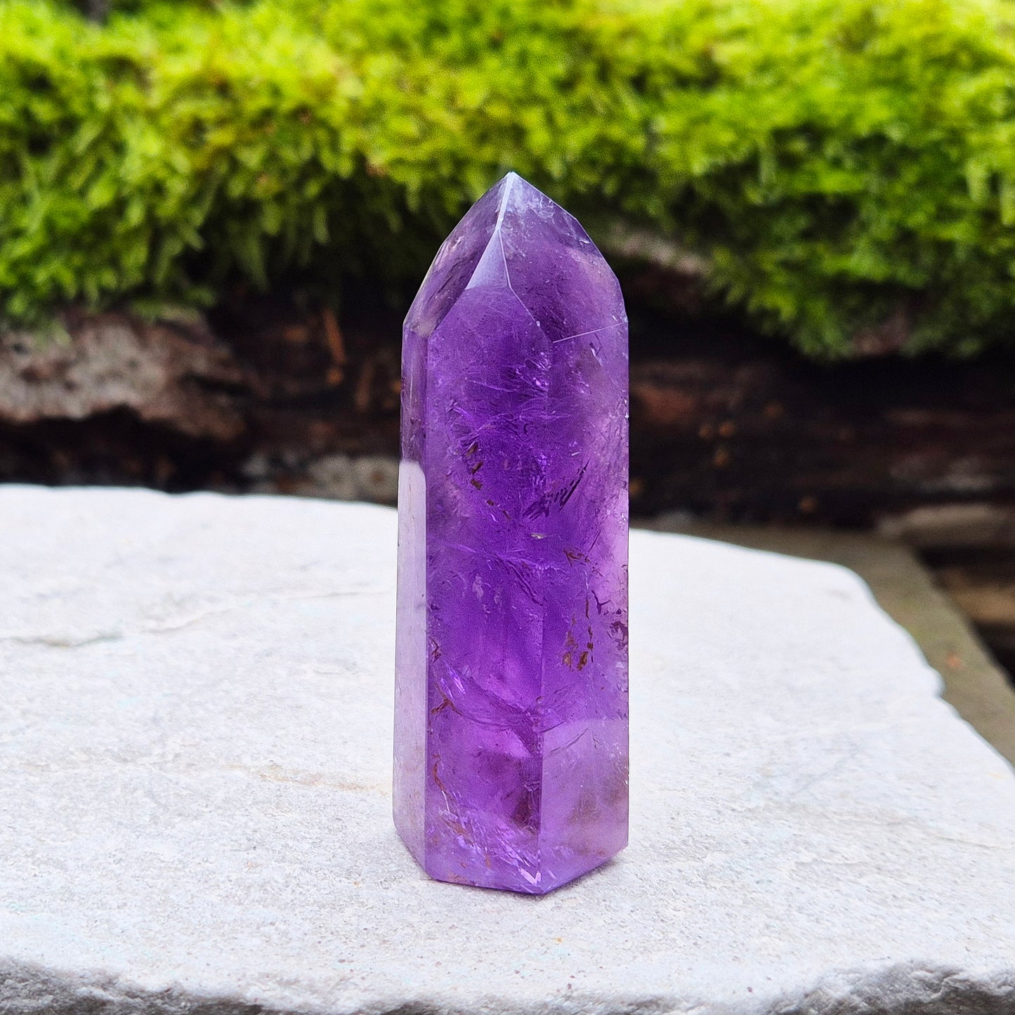 Amethyst Crystal Point from Brazil. Nice dark purple colouring with a patch of quartz at the base of the tower giving it a unique look.