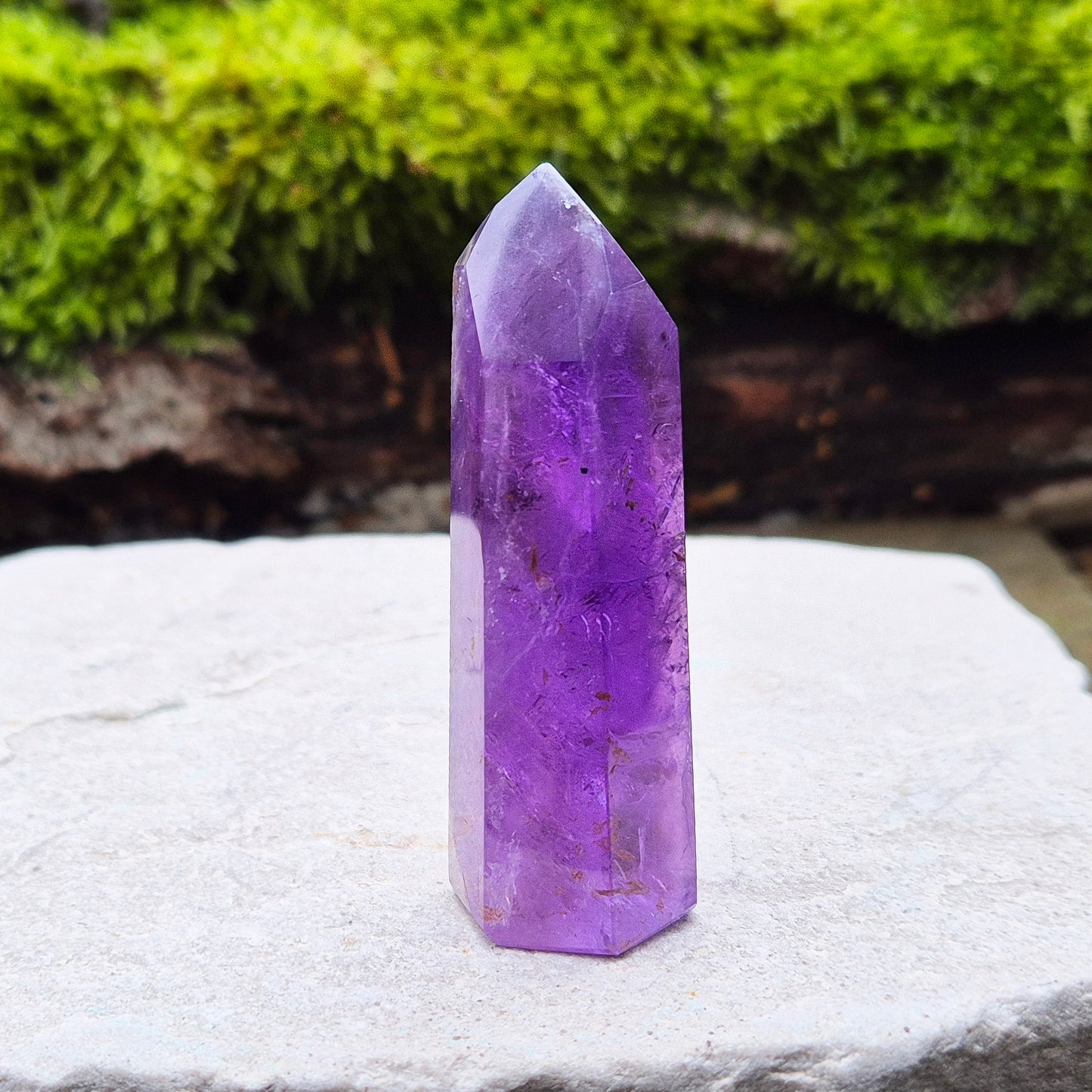 Amethyst Crystal Point from Brazil. Nice dark purple colouring with a patch of quartz at the base of the tower giving it a unique look.