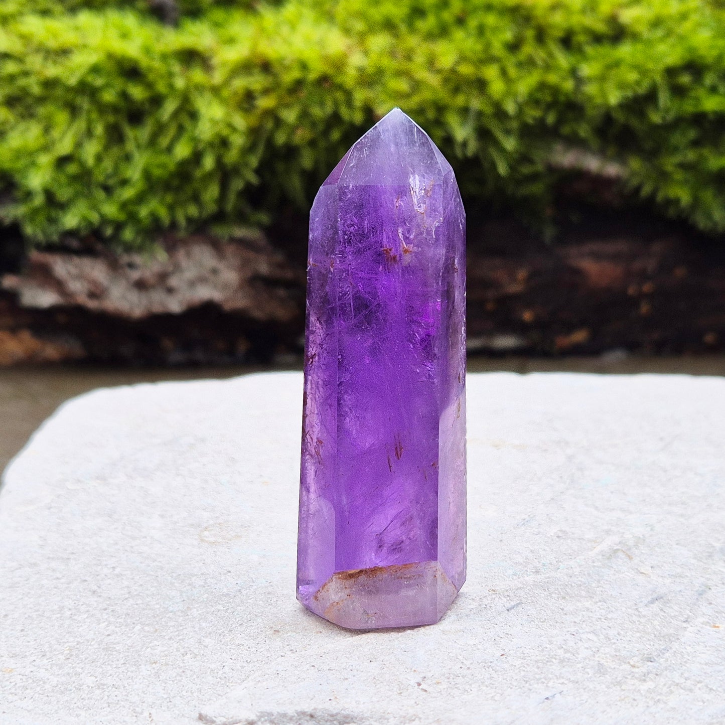 Amethyst Crystal Point from Brazil. Nice dark purple colouring with a patch of quartz at the base of the tower giving it a unique look.