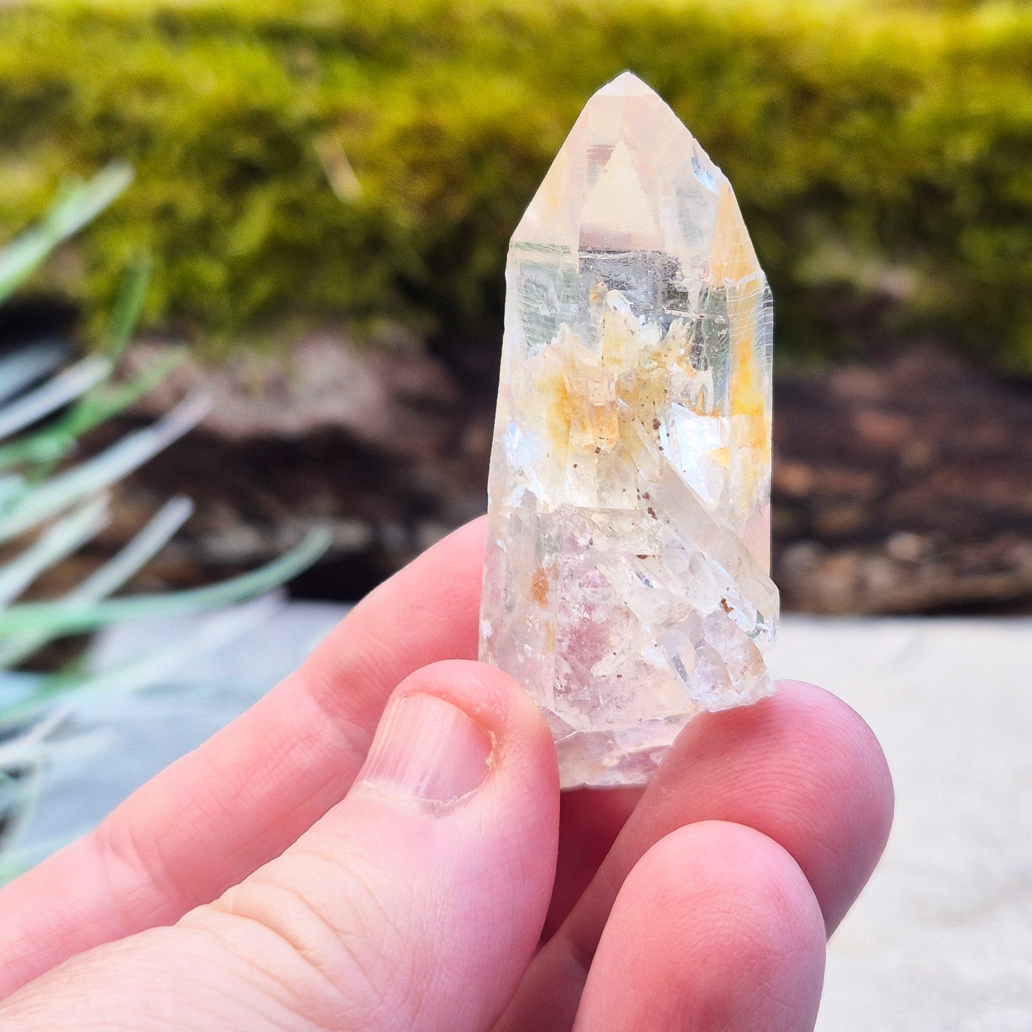 This rare Blade of Light Quartz is a striking Lemurian Quartz from the mountains of Colombia. Known for its exceptional clarity and natural brilliance, this piece features a point that has a few smaller crystals growing out of/into it.