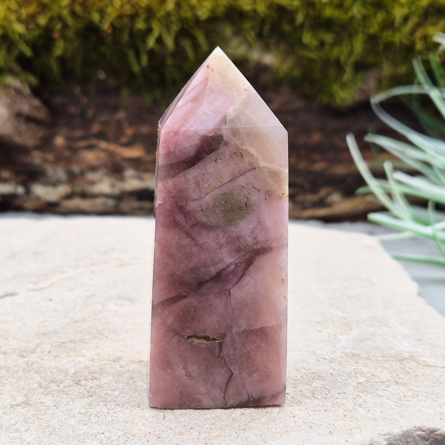 Pink Tourmaline in Quartz Crystal Point
This polished crystal tower features the soft, rosy tones of Pink Tourmaline set within the clarity of Quartz—a beautiful combination known for its soothing and supportive energy. The pointed shape helps focus and direct energy, making it a versatile and uplifting piece.