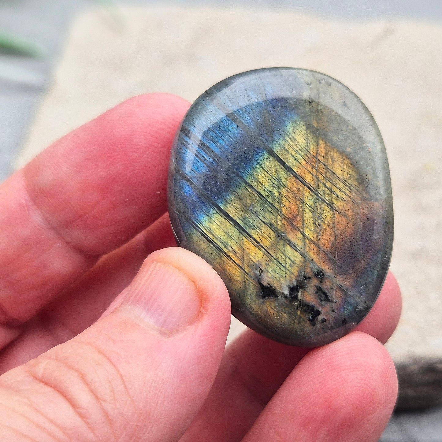 Labradorite Crystal Palm Stone, also known as Spectrolite. From Madagaascar. Has a lovely blue, yellow, gold, pinky purple flash when in the light at certain angles.
