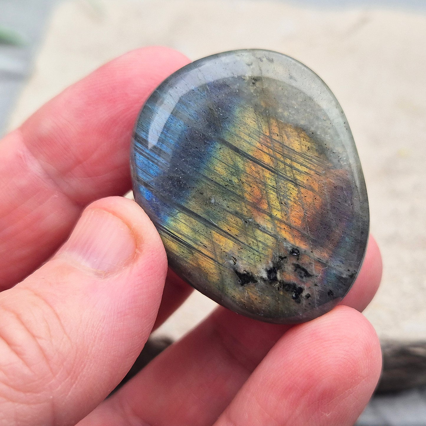 Labradorite Crystal Palm Stone, also known as Spectrolite. From Madagaascar. Has a lovely blue, yellow, gold, pinky purple flash when in the light at certain angles.