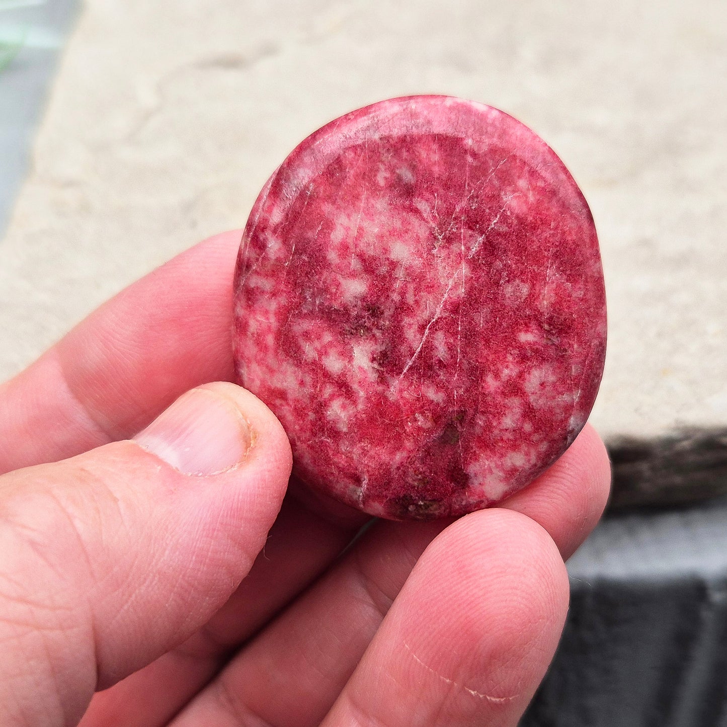 This beautiful Pink Thulite palm stone, also known as Rosaline, features a vibrant natural pink colour and fits comfortably in your hand. Pink Thulite is celebrated for its warm, uplifting energy.
