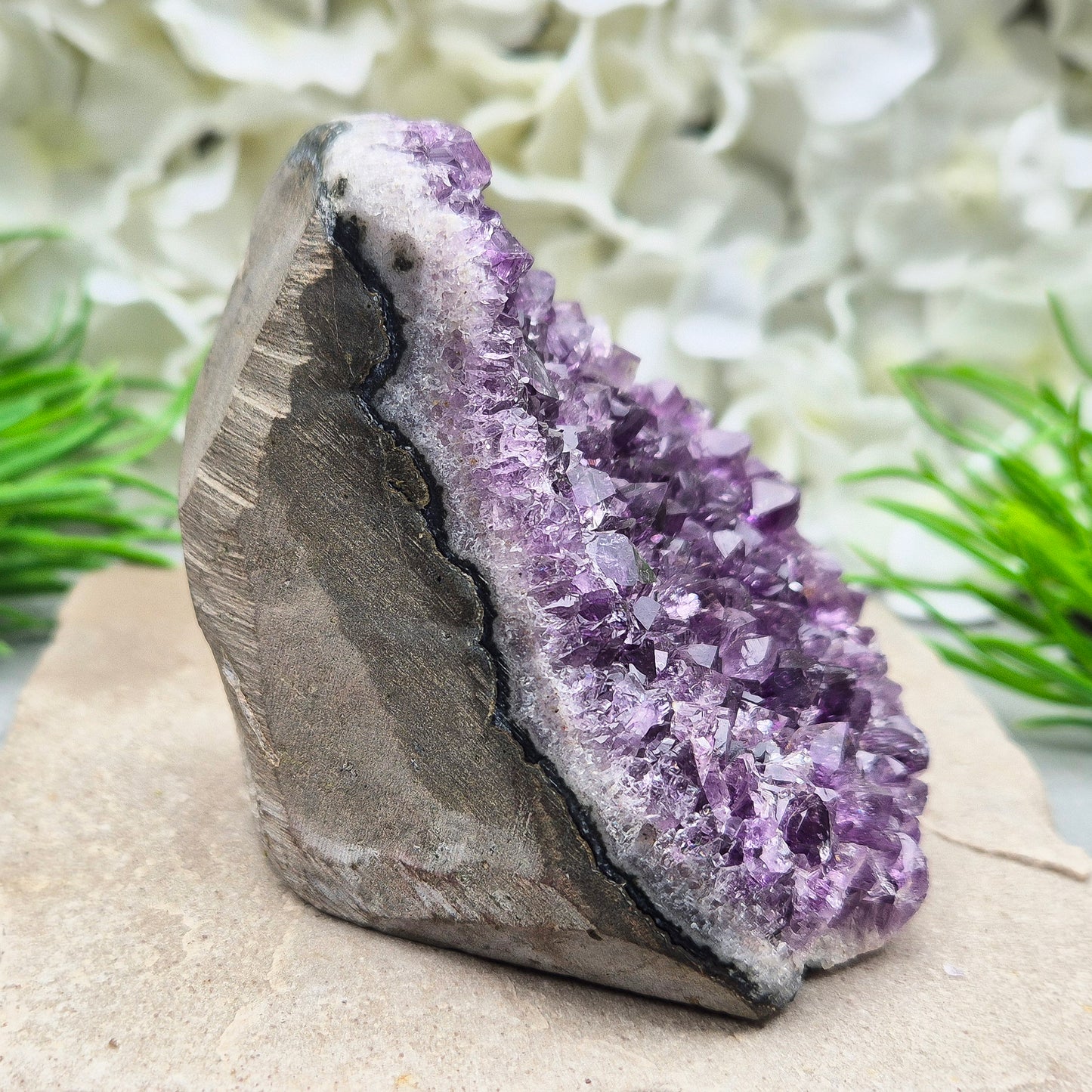 Amethyst Self-Standing Geode. This beautiful self-standing Amethyst Geode comes from Brazil. With its deep violet points and natural open-face formation, this piece offers both strength and serenity.