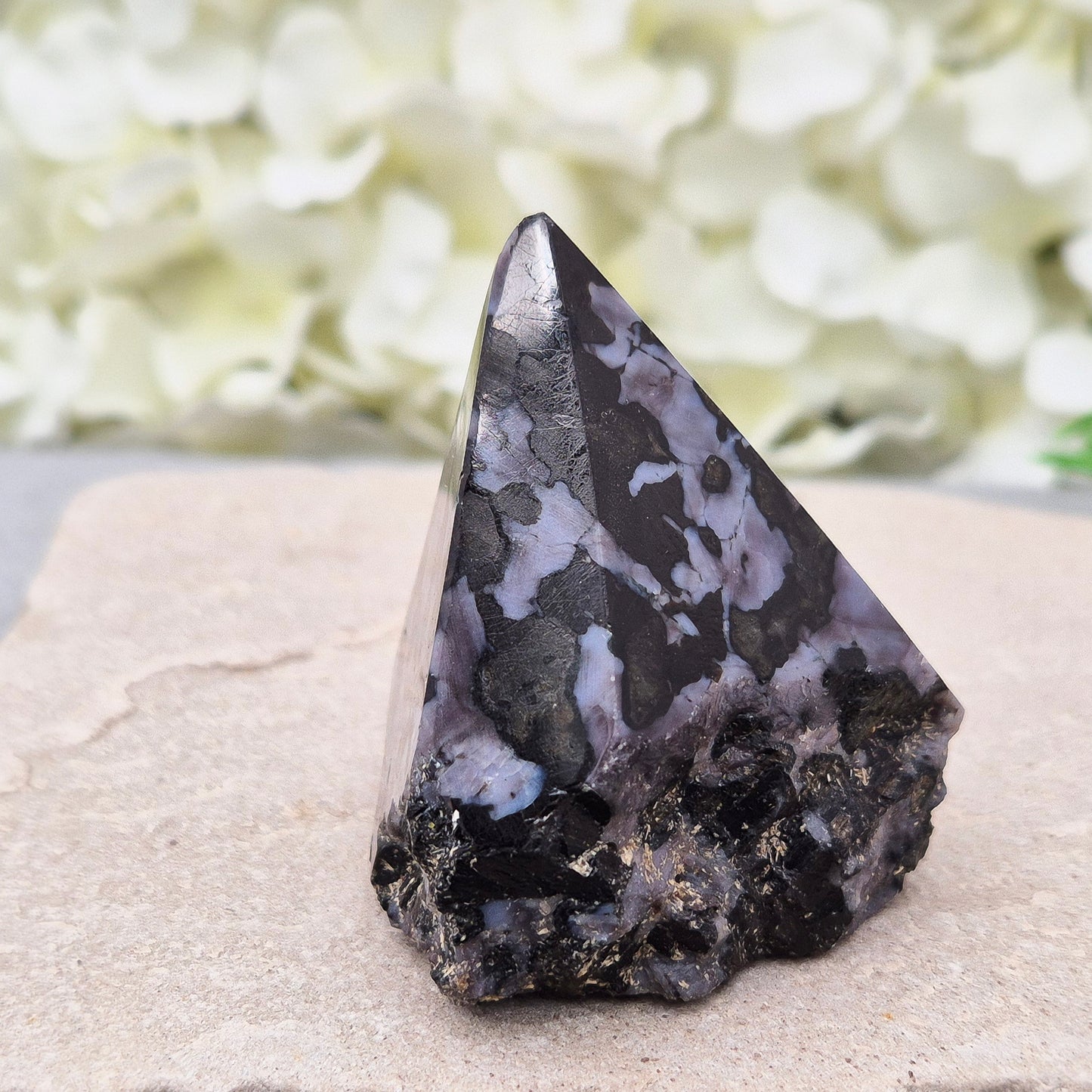 Indigo Gabbro Crystal Point (Mystic Merlinite) from Madagascar. This Indigo Gabbro point features a mix of dark black and deep purple colours. The top is polished, the base cut flat, and the sides left natural.