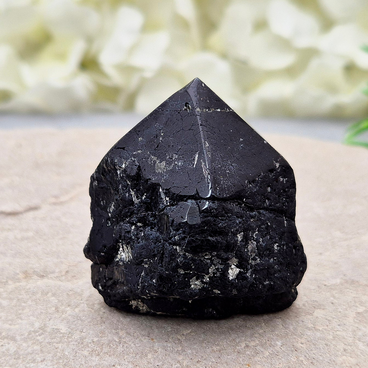 Black Tourmaline point from Brazil, which has polished tip, natural sides and cut flatbase. Contains a few sparkly Mica inclusions. A perfect piece for anyone needing strong protection, energetic clarity, and emotional strength.