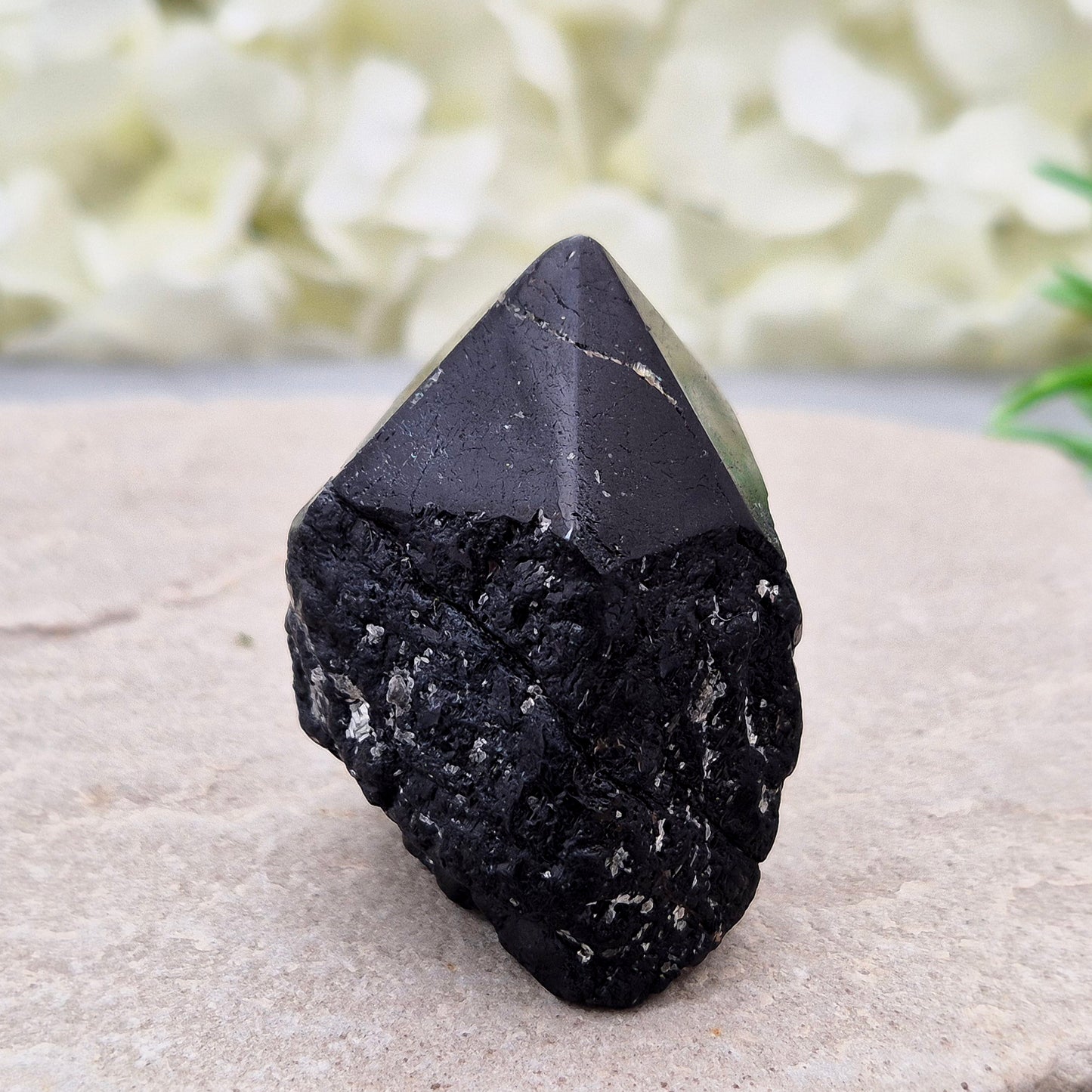 Black Tourmaline point from Brazil, which has polished tip, natural sides and cut flatbase. Contains a few sparkly Mica inclusions. A perfect piece for anyone needing strong protection, energetic clarity, and emotional strength.