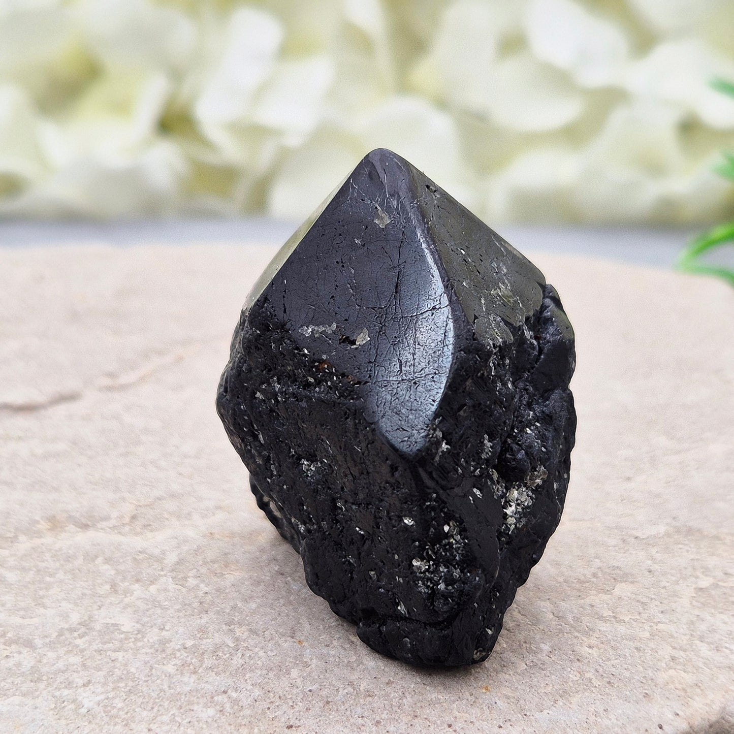 Black Tourmaline point from Brazil, which has polished tip, natural sides and cut flatbase. Contains a few sparkly Mica inclusions. A perfect piece for anyone needing strong protection, energetic clarity, and emotional strength.