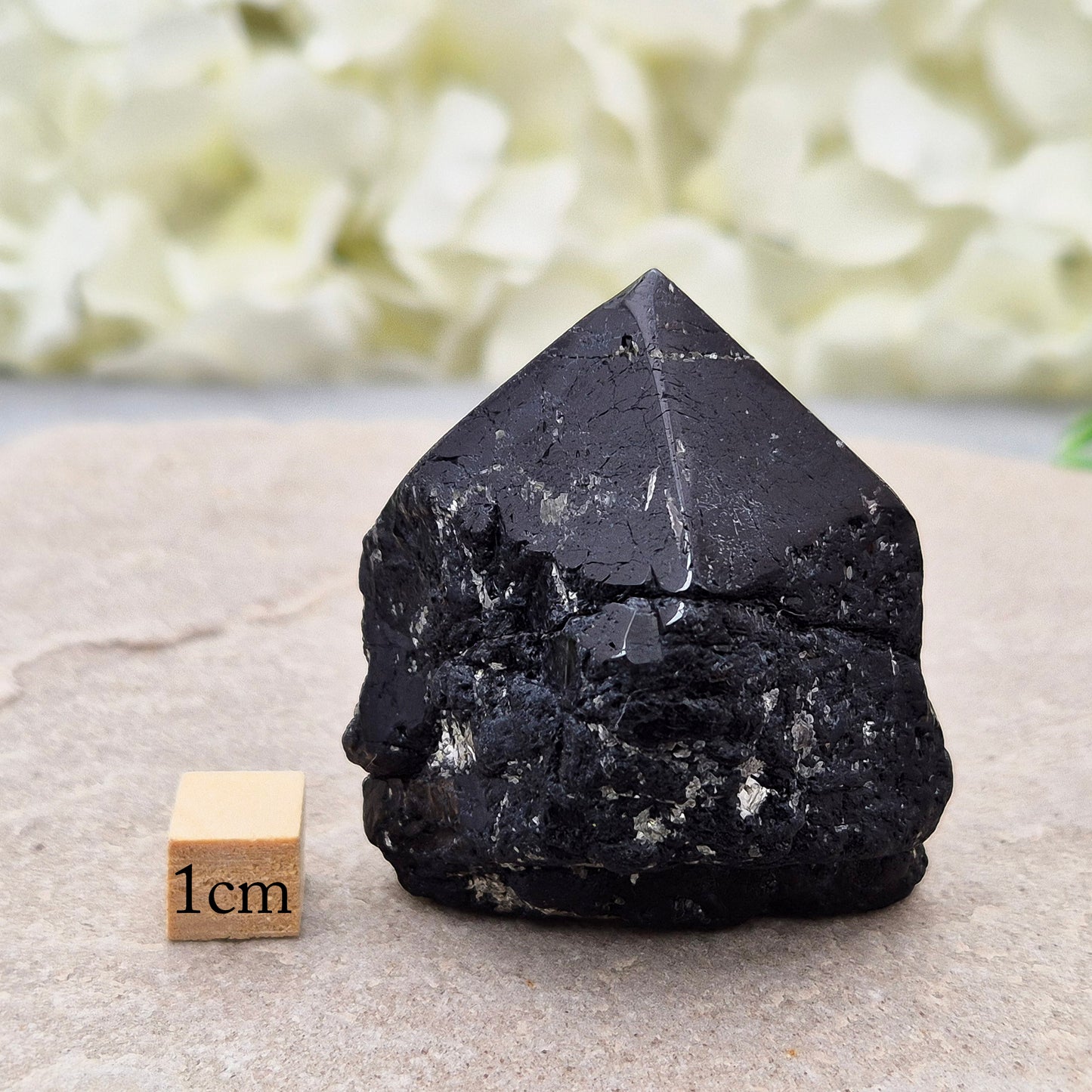 Black Tourmaline point from Brazil, which has polished tip, natural sides and cut flatbase. Contains a few sparkly Mica inclusions. A perfect piece for anyone needing strong protection, energetic clarity, and emotional strength.