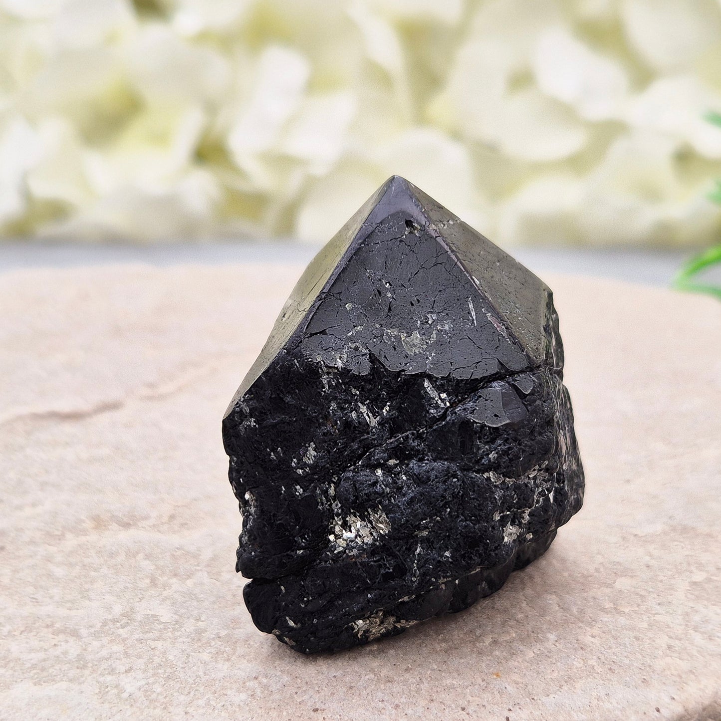 Black Tourmaline point from Brazil, which has polished tip, natural sides and cut flatbase. Contains a few sparkly Mica inclusions. A perfect piece for anyone needing strong protection, energetic clarity, and emotional strength.