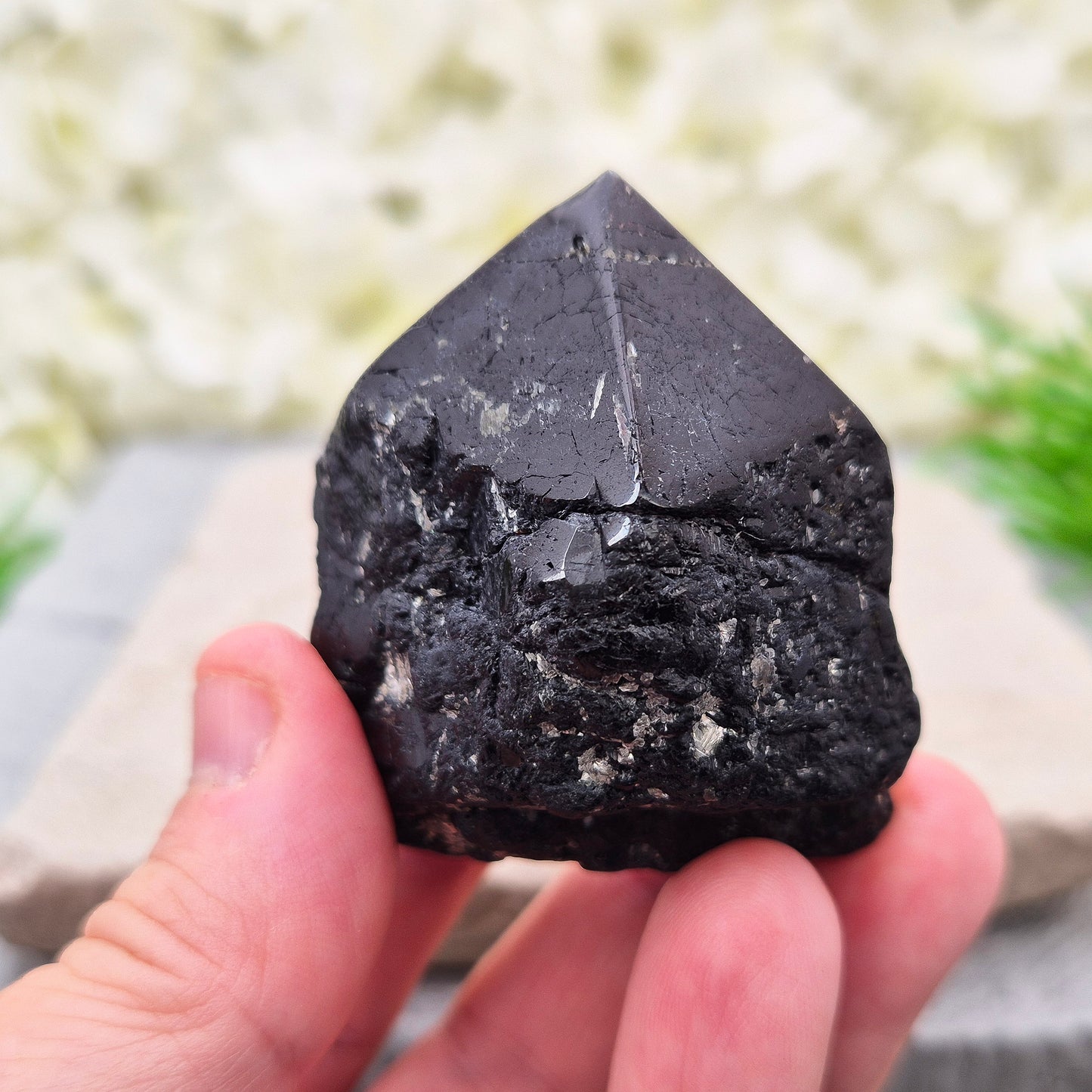 Black Tourmaline point from Brazil, which has polished tip, natural sides and cut flatbase. Contains a few sparkly Mica inclusions. A perfect piece for anyone needing strong protection, energetic clarity, and emotional strength.