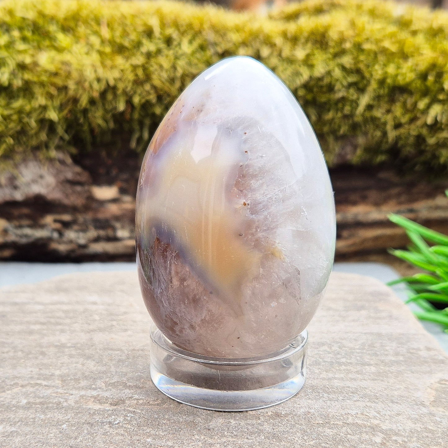 This beautiful Druzy Agate egg from Brazil is polished and showcases a sparkling pocket of natural druzy crystals in the middle of it. It comes with a clear acrylic stand, making it a lovely addition to any space or crystal shelf. Its soft, steady energy brings emotional calm, grounding, and quiet strength.