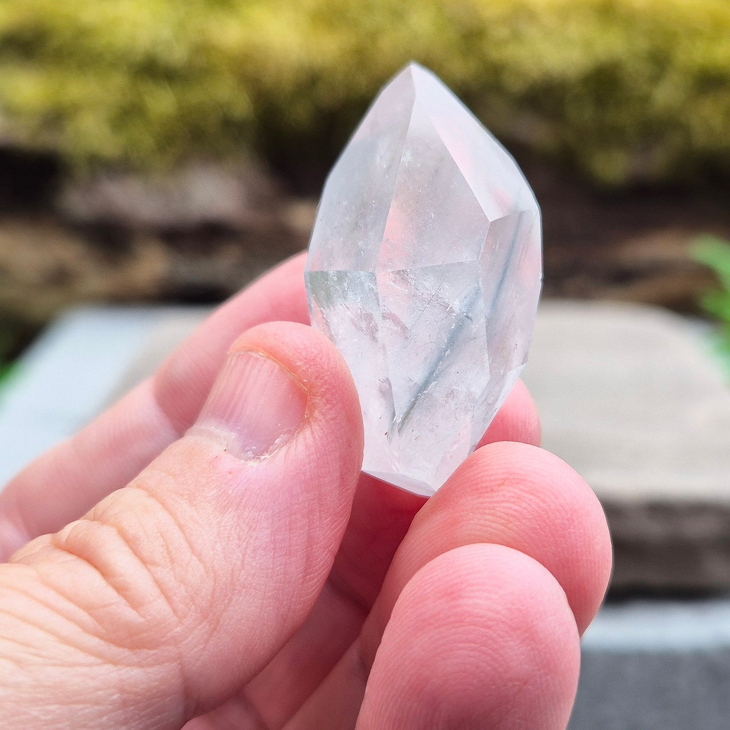 Blue Tara, also known as Indicolite Quartz, is a rare and visually captivating crystal from Brazil. This polished piece features fine, natural inclusions of Blue Tourmaline suspended like mist or needles within clear Quartz.