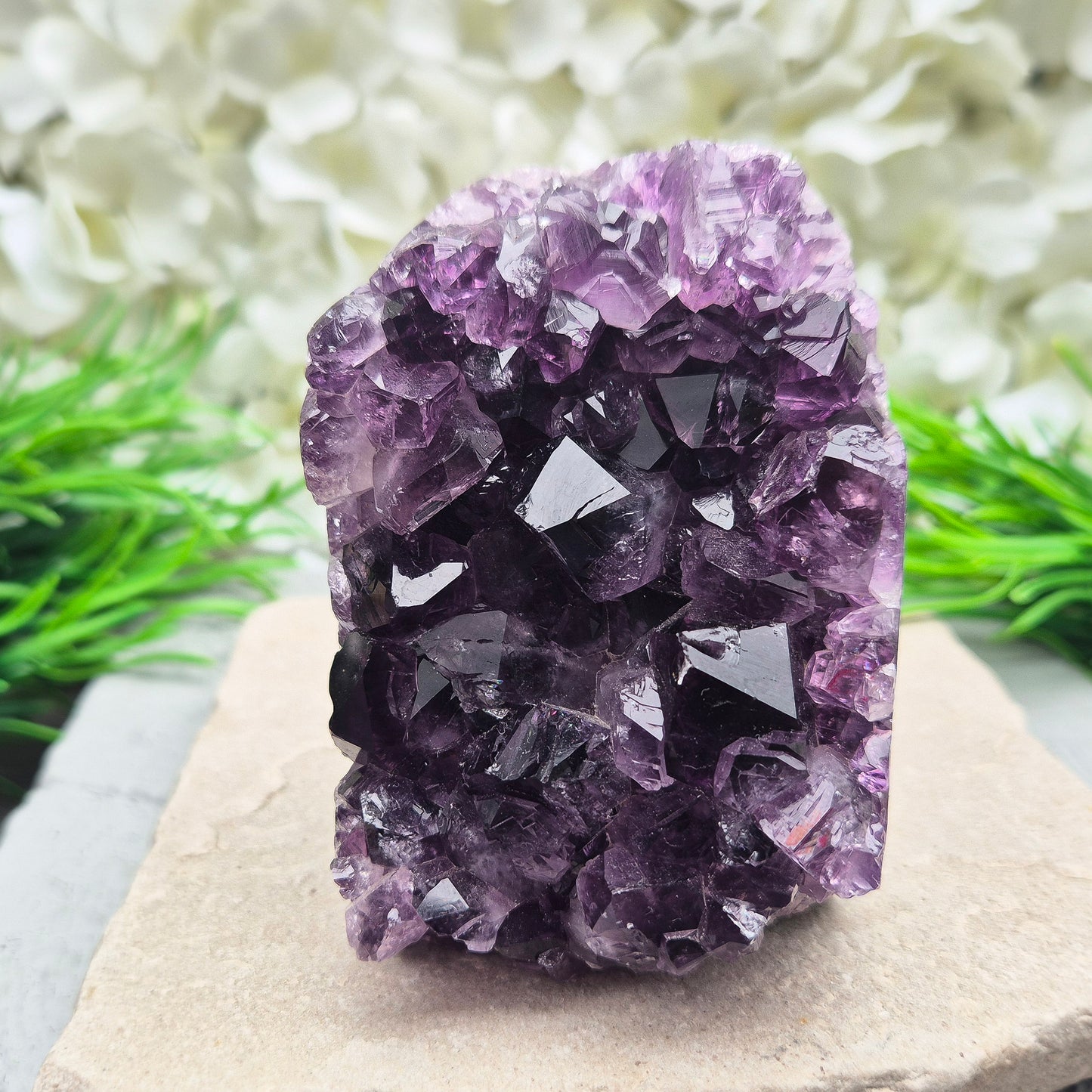 This beautiful self-standing Amethyst Geode from Brazil features lovely deep purple points and a natural open-face formation. Its deep colour and solid structure bring both visual beauty and a quiet strength to any space.