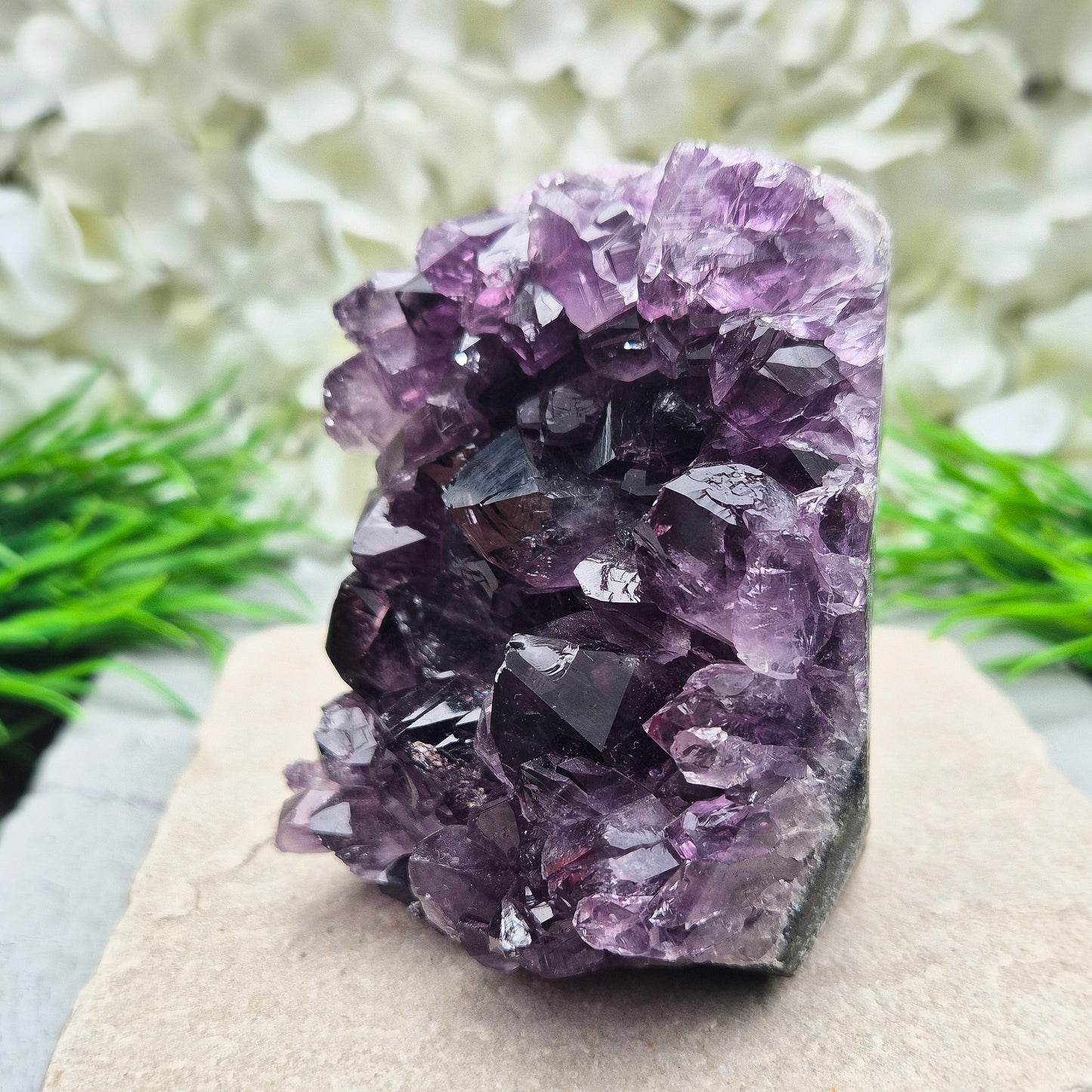 This beautiful self-standing Amethyst Geode from Brazil features lovely deep purple points and a natural open-face formation. Its deep colour and solid structure bring both visual beauty and a quiet strength to any space.