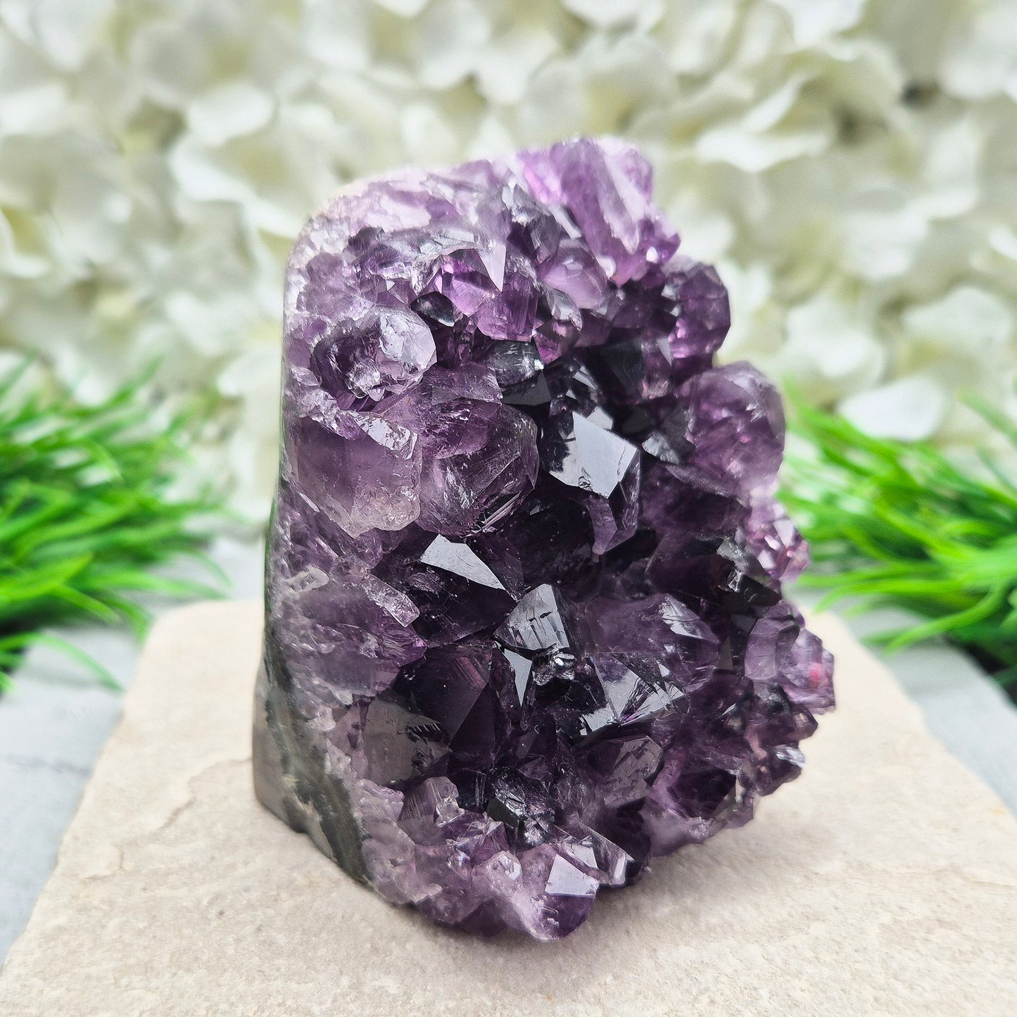 This beautiful self-standing Amethyst Geode from Brazil features lovely deep purple points and a natural open-face formation. Its deep colour and solid structure bring both visual beauty and a quiet strength to any space.