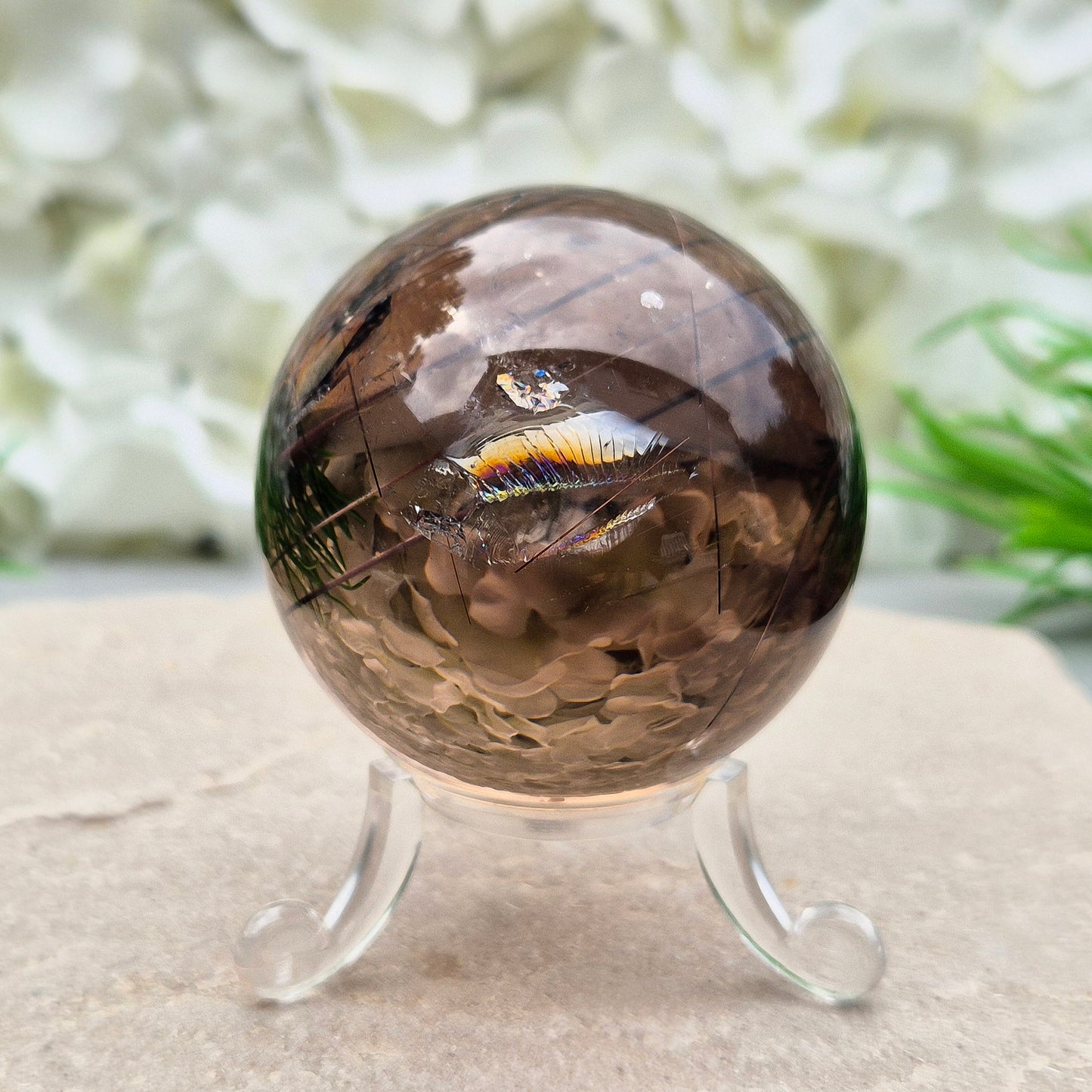 Stunning rare and collectible smoky quartz sphere, with fiery copper red rutile needles inclusions and with a rainbow flash.