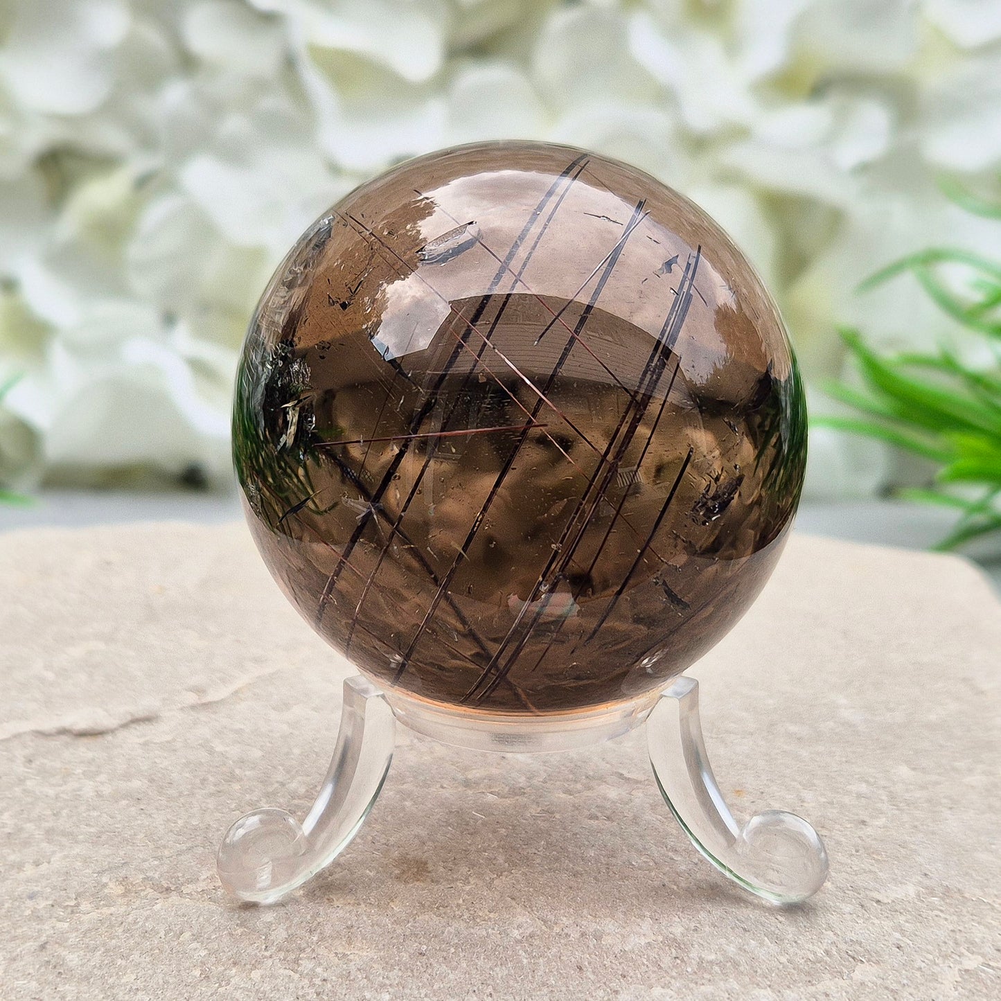 Stunning rare and collectible smoky quartz sphere, with fiery copper red rutile needles inclusions and with a rainbow flash.