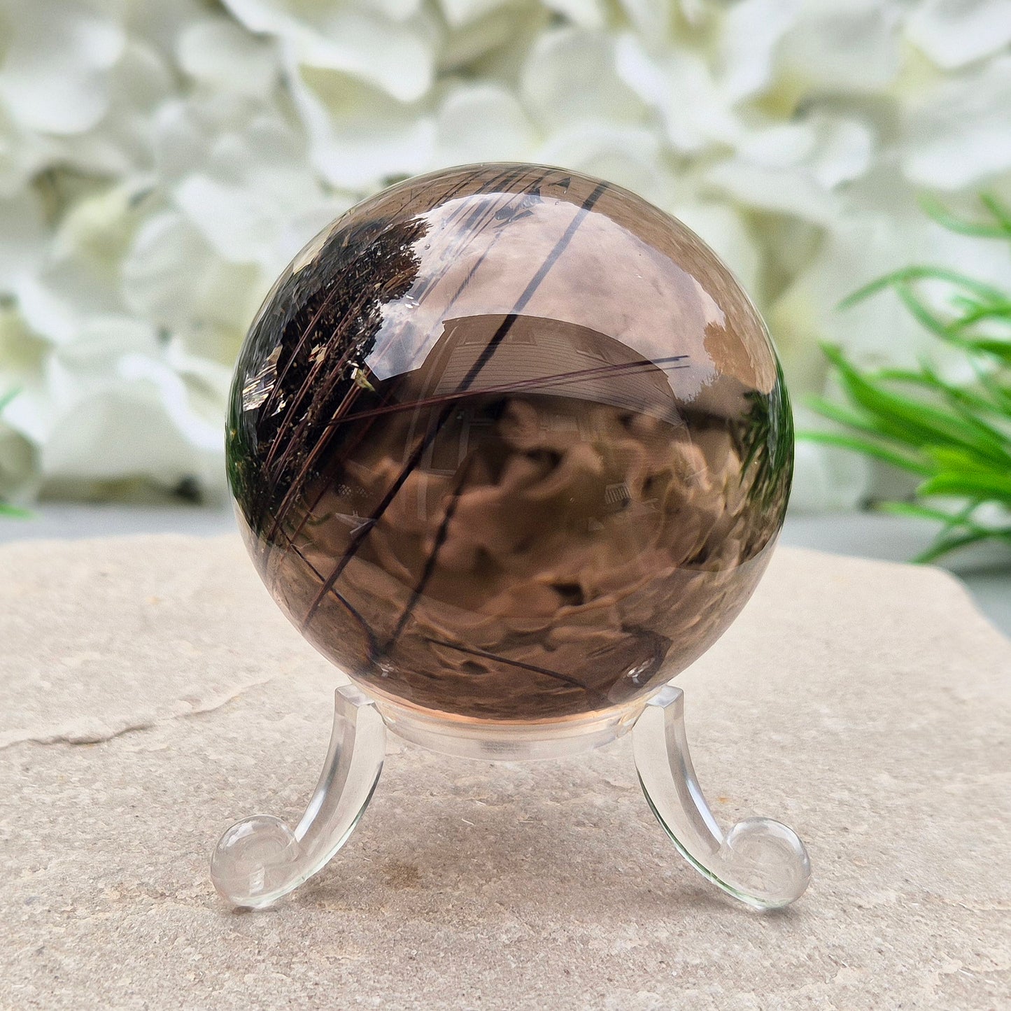Stunning rare and collectible smoky quartz sphere, with fiery copper red rutile needles inclusions and with a rainbow flash.
