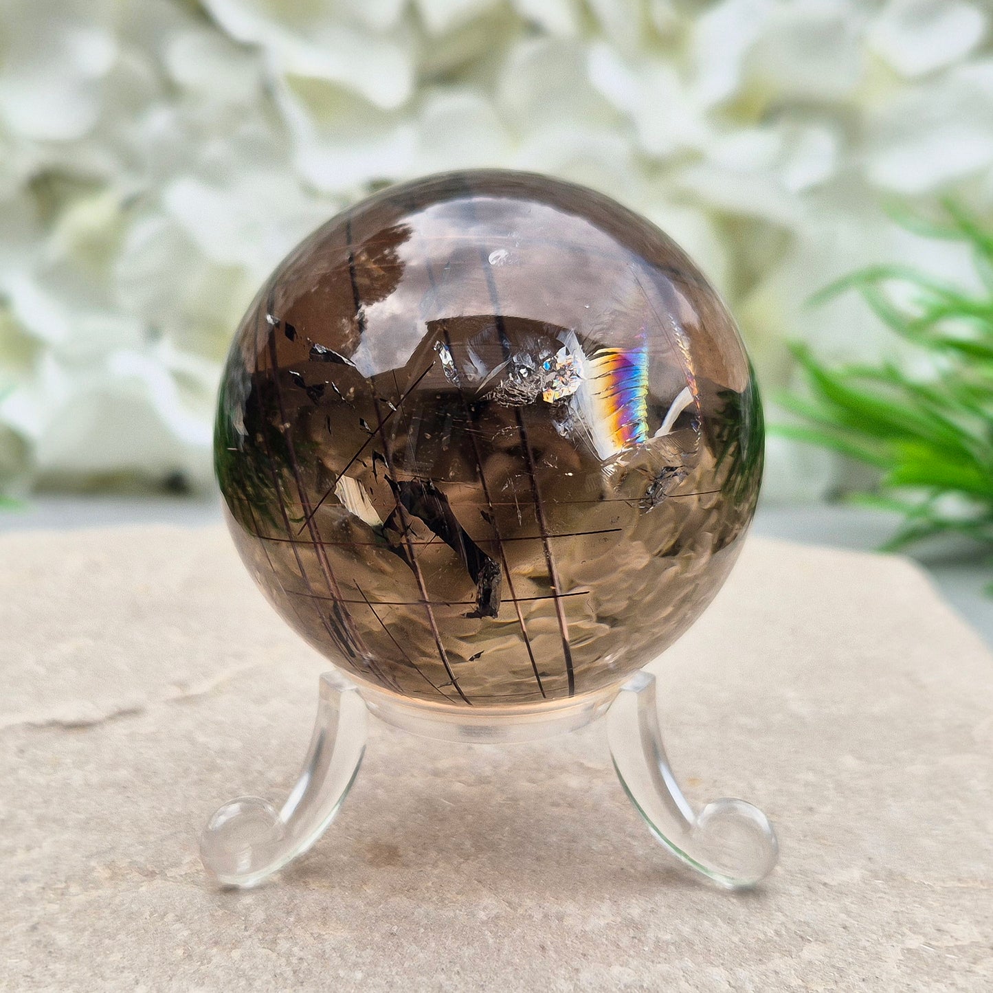 Stunning rare and collectible smoky quartz sphere, with fiery copper red rutile needles inclusions and with a rainbow flash.